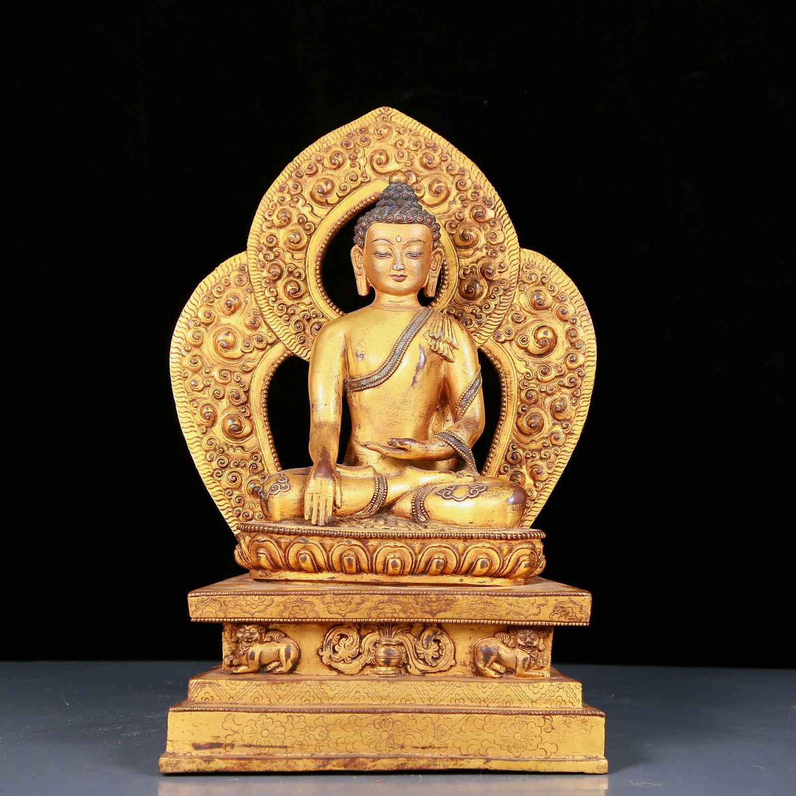 A stunning gilt bronze statue of Sakyamuni: stunning gilt bronze statue of Sakyamuni, Ming Dynasty, China. The Buddha's face has a calm, kind and serene expression, and his hands and fingers show beautiful lines and proportions to demonstrate t
