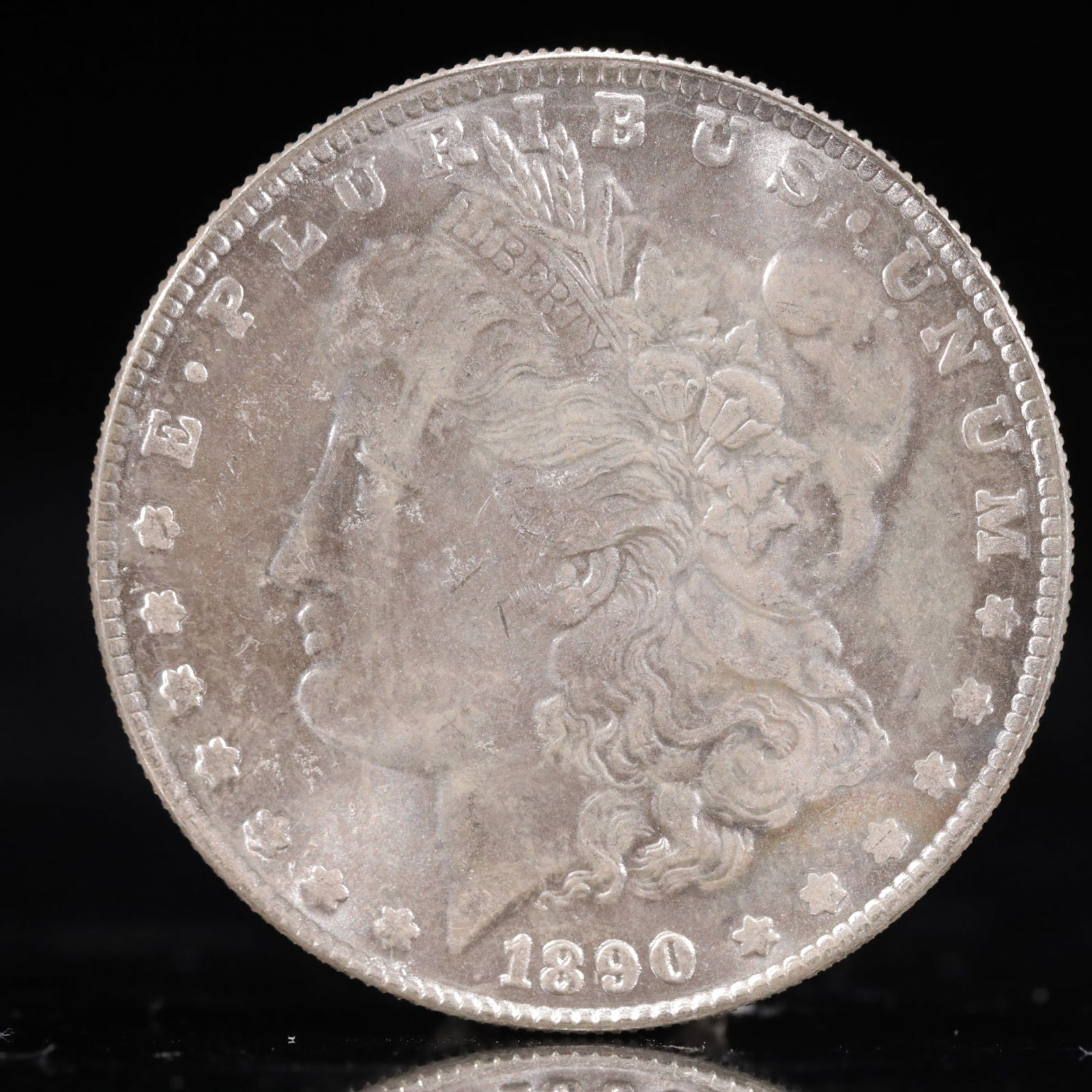 USA Morgan Dollar 1890 Coin: Obv: profile bust with date below and E PLURIBUS UNUM legend and stars around. Rev: eagle with In God we trust above within wreath with UNITED STATES OF AMERICA ONE DOLLAR legend. IN GOD WE TRUST /