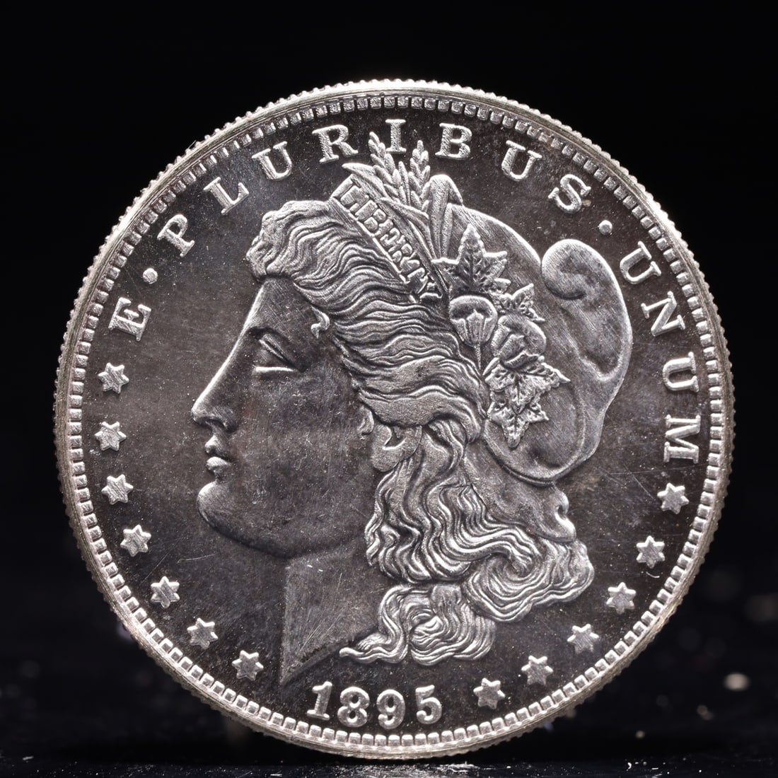 USA Morgan Dollar 1895 Coin: Obv: profile bust with date below and E PLURIBUS UNUM legend and stars around. Rev: eagle with In God we trust above within wreath with UNITED STATES OF AMERICA ONE DOLLAR legend. IN GOD WE TRUST / LI