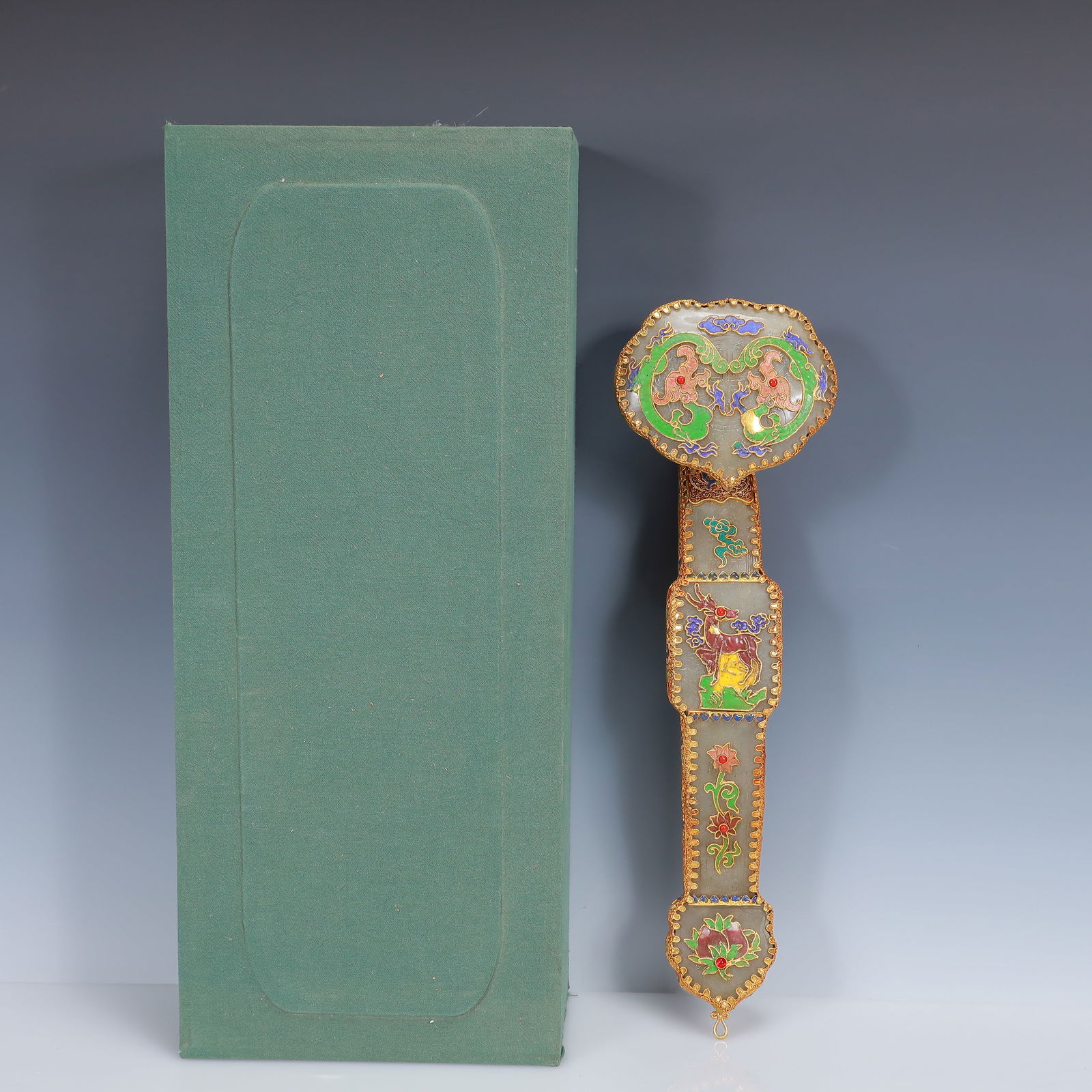 An Exquisite Filigree and Gilding Inlaid Greenish Jade Flower Pattern Ruyi Ornament,Inlaid Gems: An Exquisite Filigree and Gilding Inlaid Greenish Jade Flower Pattern Ruyi Ornament,Inlaid Gems,Qing Dynasty, China,Qianlong Four-Character Mark,Size:14.6inx4.3inx2.8in,(Box)18.5inx7.9inx4.3in,Weight: