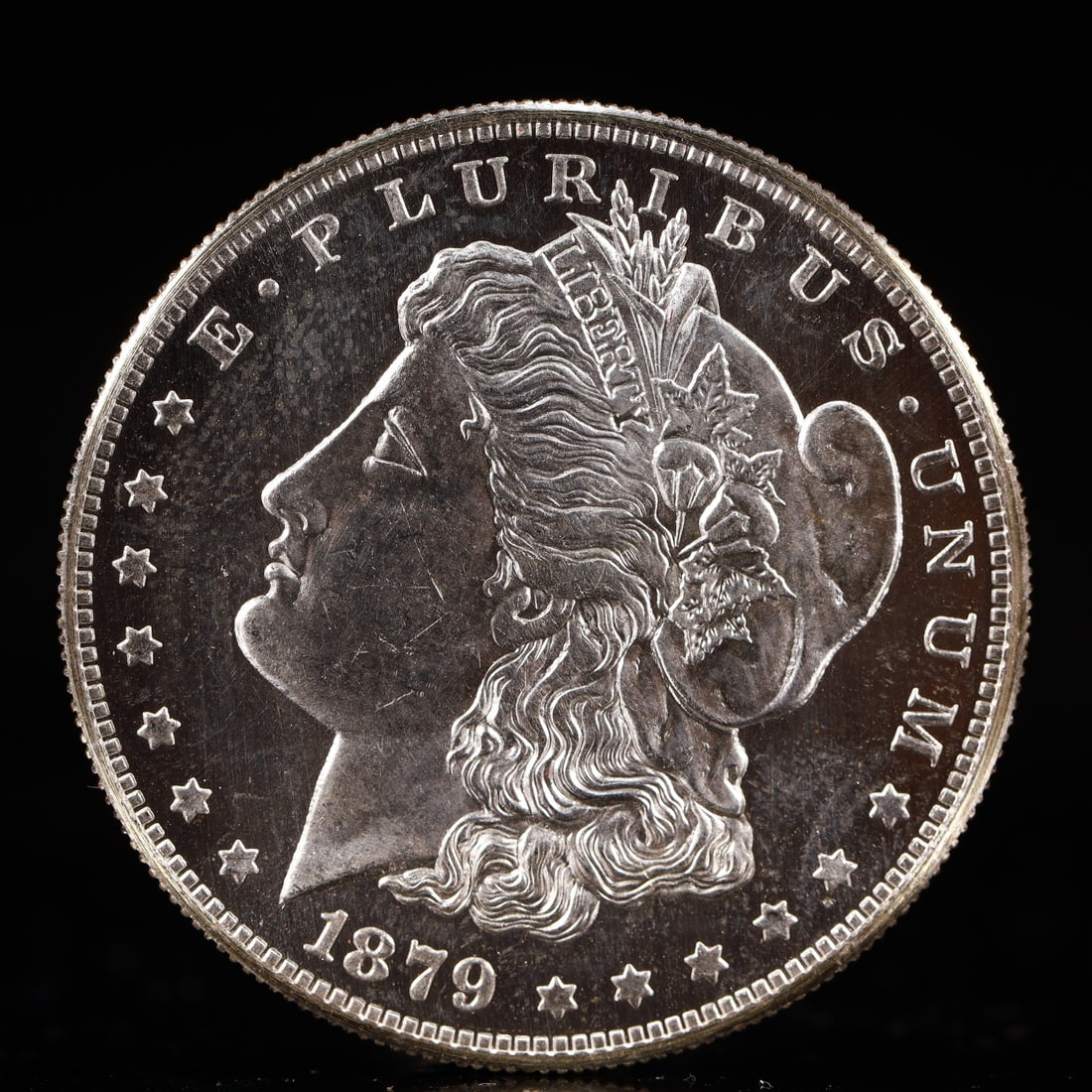 USA Morgan Dollar 1879 Coin: Obv: profile bust with date below and E PLURIBUS UNUM legend and stars around. Rev: eagle with In God we trust above within wreath with UNITED STATES OF AMERICA ONE DOLLAR legend. IN GOD WE TRUST / LI