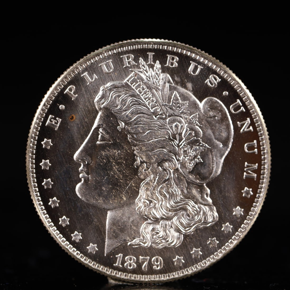 USA Morgan Dollar 1879 Coin: Obv: profile bust with date below and E PLURIBUS UNUM legend and stars around. Rev: eagle with In God we trust above within wreath with UNITED STATES OF AMERICA ONE DOLLAR legend. IN GOD WE TRUST / LI