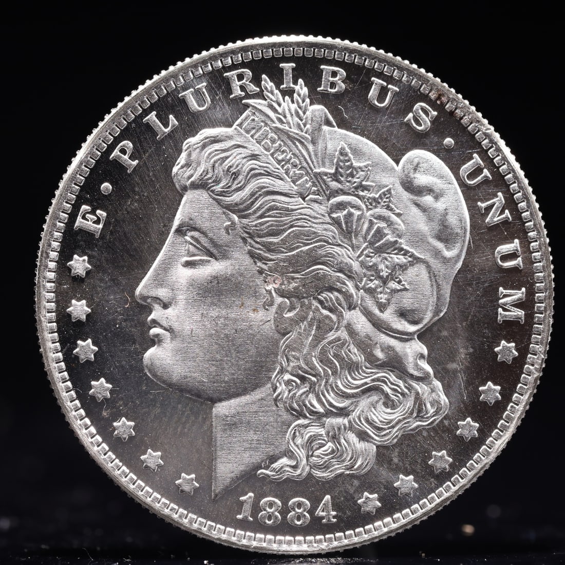 USA Morgan Dollar 1884 Coin: Obv: profile bust with date below and E PLURIBUS UNUM legend and stars around. Rev: eagle with In God we trust above within wreath with UNITED STATES OF AMERICA ONE DOLLAR legend. IN GOD WE TRUST / LI