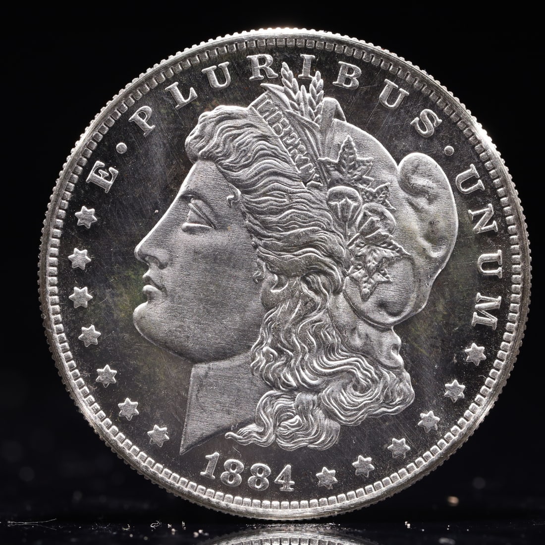 USA Morgan Dollar 1884 Coin: Obv: profile bust with date below and E PLURIBUS UNUM legend and stars around. Rev: eagle with In God we trust above within wreath with UNITED STATES OF AMERICA ONE DOLLAR legend. IN GOD WE TRUST /