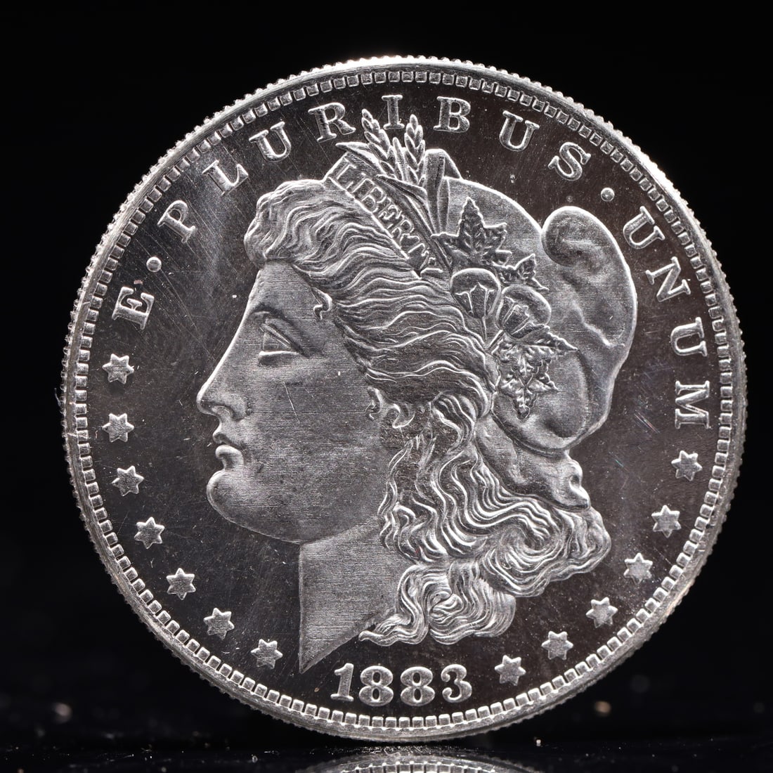 USA Morgan Dollar 1883 Coin: Obv: profile bust with date below and E PLURIBUS UNUM legend and stars around. Rev: eagle with In God we trust above within wreath with UNITED STATES OF AMERICA ONE DOLLAR legend. IN GOD WE TRUST / LI