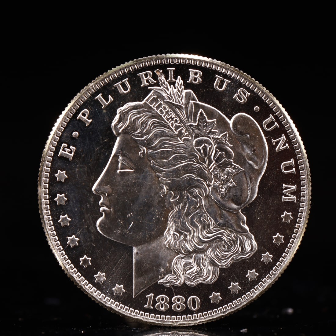 USA Morgan Dollar 1880 Coin: Obv: profile bust with date below and E PLURIBUS UNUM legend and stars around. Rev: eagle with In God we trust above within wreath with UNITED STATES OF AMERICA ONE DOLLAR legend. IN GOD WE TRUST / LI