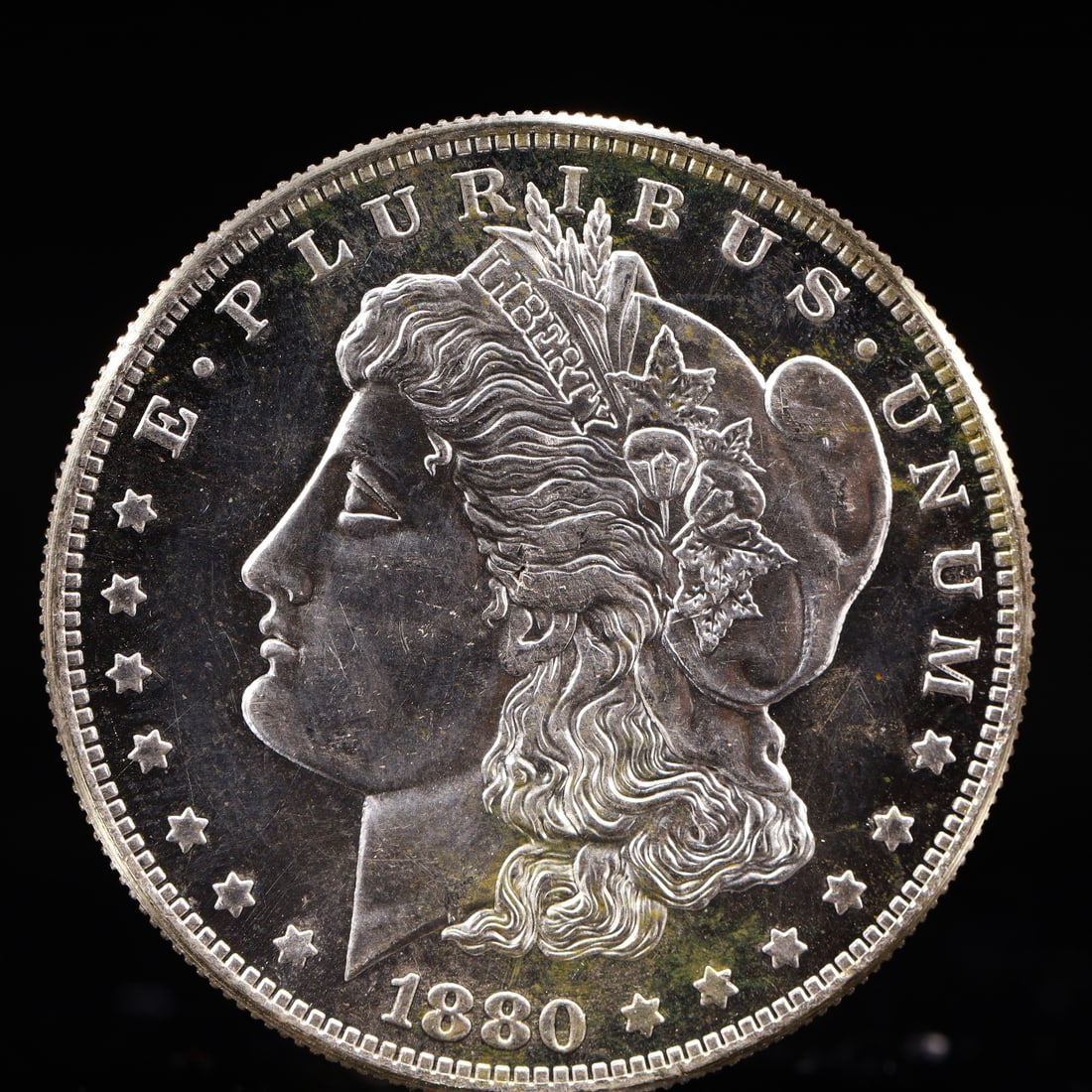 USA Morgan Dollar 1880 Coin: Obv: profile bust with date below and E PLURIBUS UNUM legend and stars around. Rev: eagle with In God we trust above within wreath with UNITED STATES OF AMERICA ONE DOLLAR legend. IN GOD WE TRUST / LI