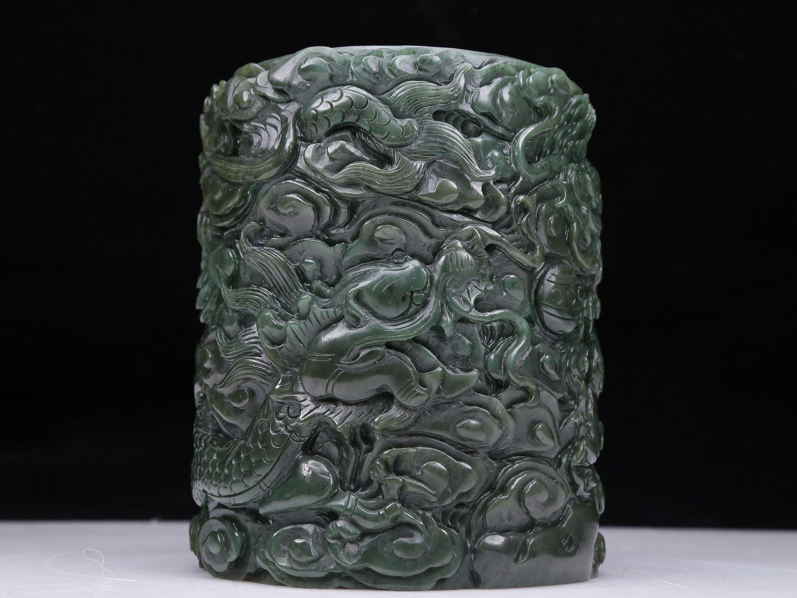 A Precious Jasper 'Dragon& Auspicious Cloud' Brush Pot: A Precious Jasper 'Dragon& Auspicious Cloud' Brush Pot. The exterior is carved in detail with scaly, sinuous dragons writhing amidst dense clouds. Chinese Qing Dynasty. Size:5.9inx6.9in. Weight:4735g