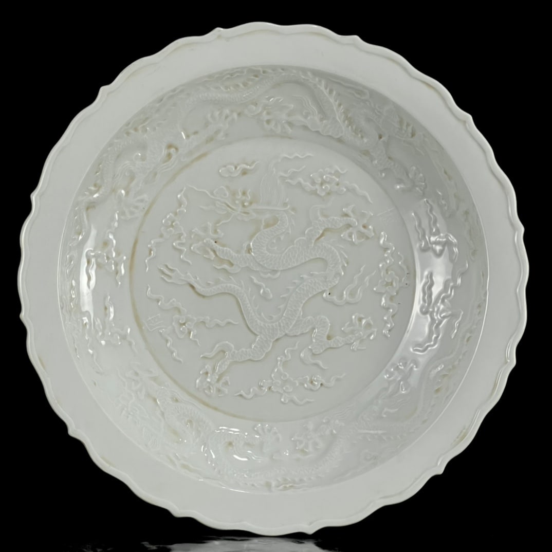 A Rare White Glazed Auspicious Cloud and Dragon Pattern Plate: A Rare White Glazed Auspicious Cloud and Dragon Pattern Plate,Qing Dynasty, China,Size:2.2inx13.2in 白釉祥云龙纹盘,中国清代