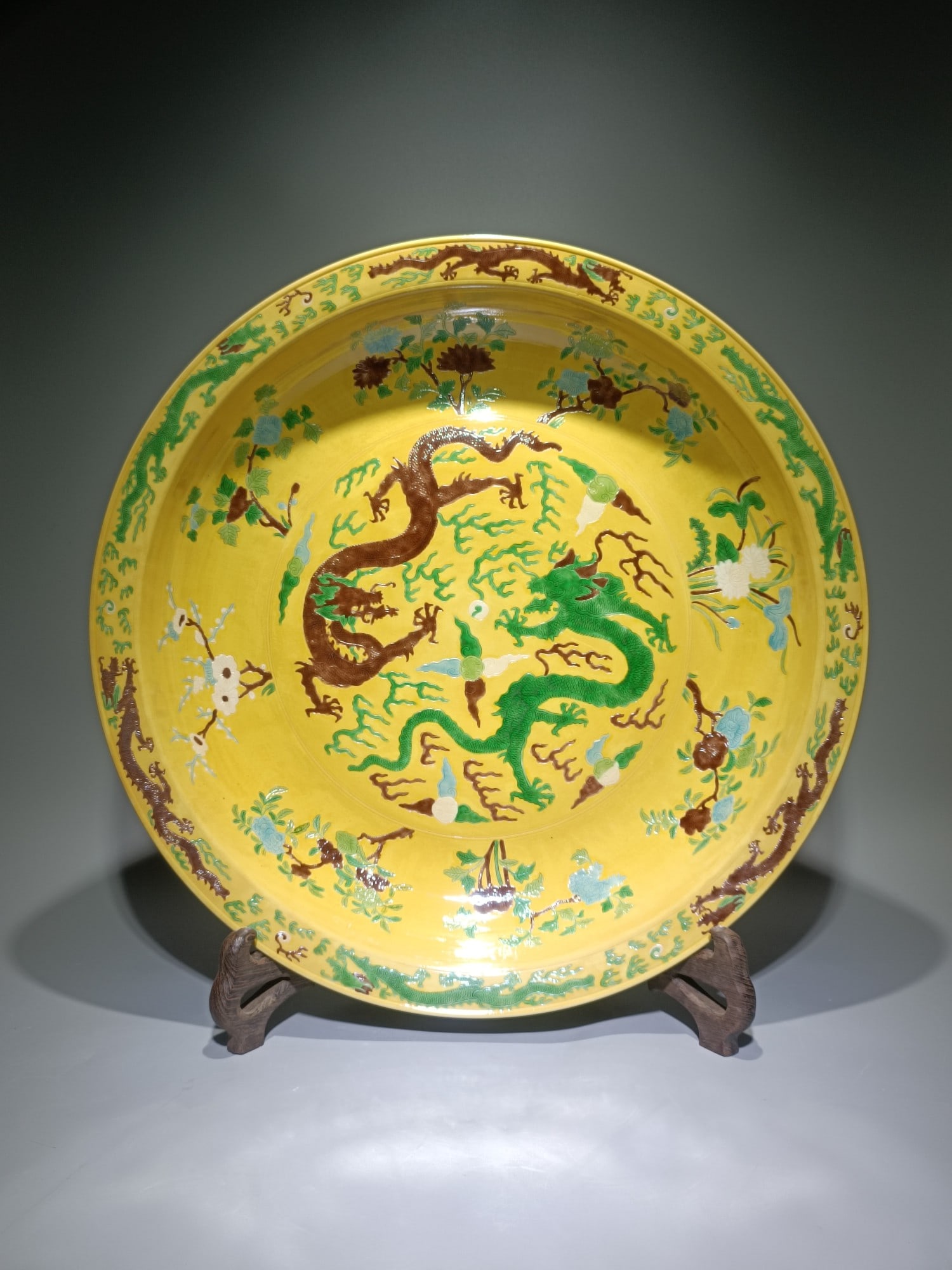 A Huge Yellow Ground Biscuit Flower and Dragon Pattern Plate: A Huge Yellow Ground Biscuit Flower and Dragon Pattern Plate,Qing Dynasty,China,Kangxi Six-character Mark,Size:20.5inx3.5in 黄地素三彩花卉龙纹