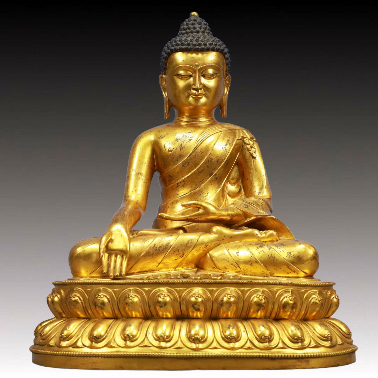 A Solemn Gilt Bronze Statue of Sakyamuni: A Solemn Gilt Bronze Statue of Sakyamuni,Qing Dynasty, China,Size:12.6inx8.7inx15.7in,Weight:11950g 铜鎏金如来像,中国清代