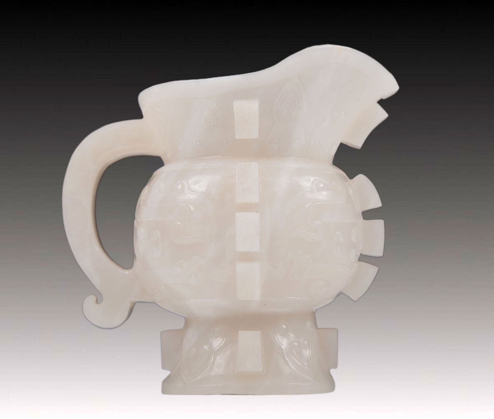 An Exquisite White Jade 'Animal Mask' Cup: An Exquisite White Jade 'Animal Mask' Cup. Carved with rows of flanges. Chinese Qing Dynasty. Size:4.1inx2.6inx4.3in. Weight:285g