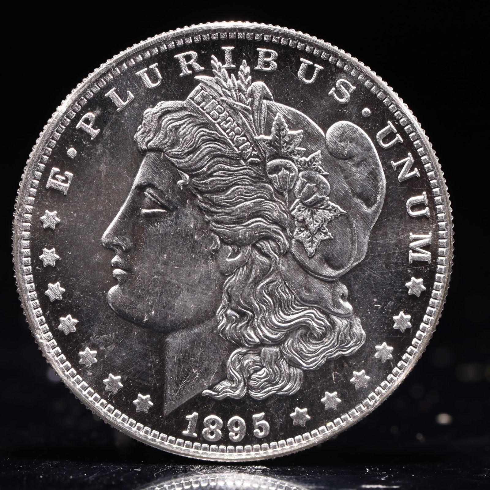 USA Morgan Dollar 1895 Coin: Obv: profile bust with date below and E PLURIBUS UNUM legend and stars around. Rev: eagle with In God we trust above within wreath with UNITED STATES OF AMERICA ONE DOLLAR legend. IN GOD WE TRUST / LI