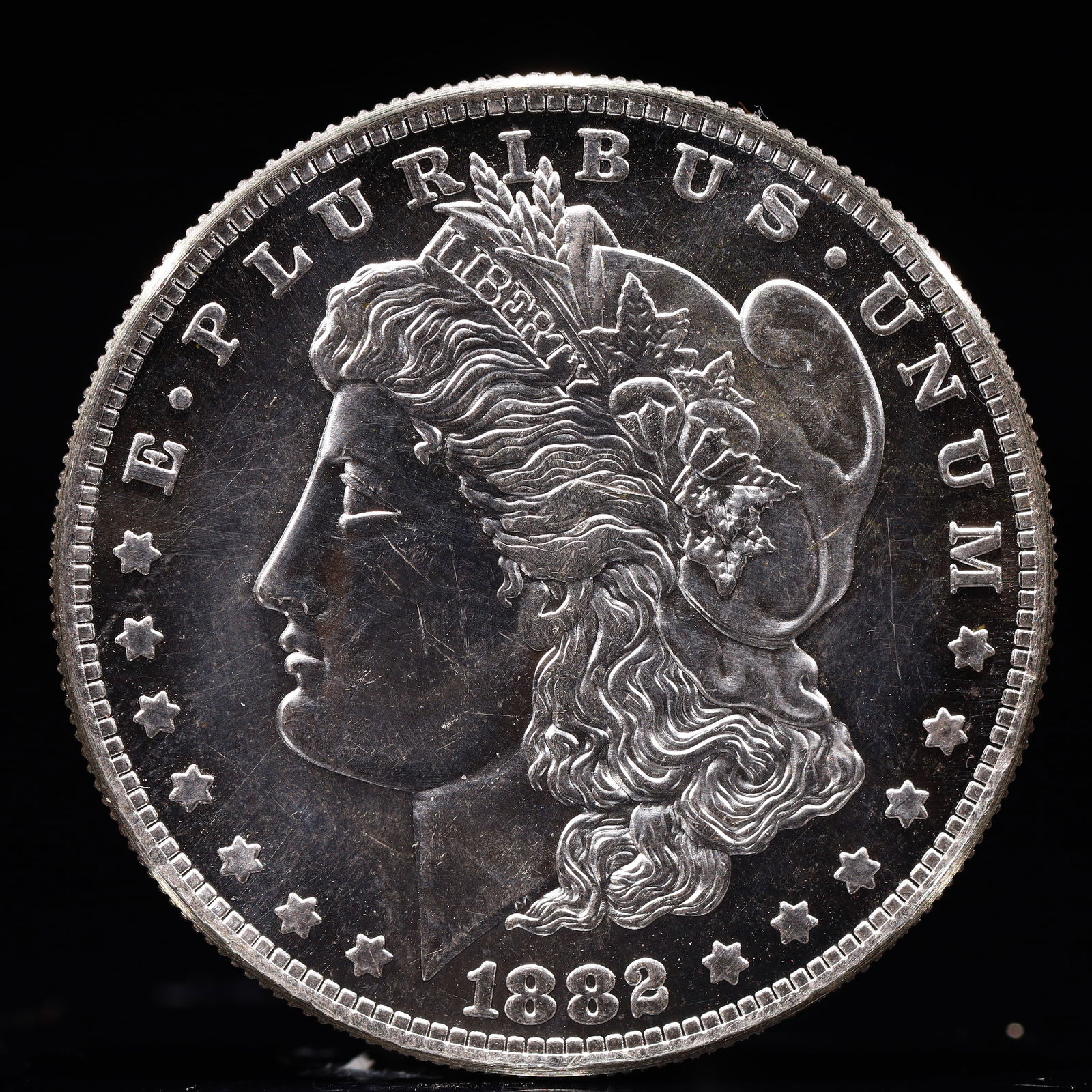 USA Morgan Dollar 1882 Coin: Obv: profile bust with date below and E PLURIBUS UNUM legend and stars around. Rev: eagle with In God we trust above within wreath with UNITED STATES OF AMERICA ONE DOLLAR legend. IN GOD WE TRUST /