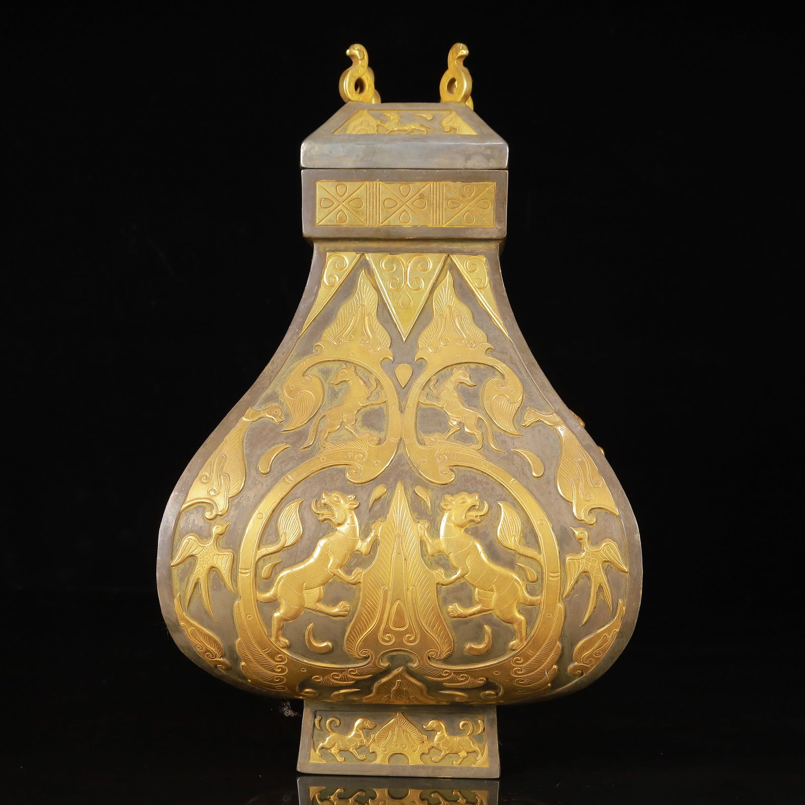 An Exquisite Gilt Silver Auspicious Beast Pattern Beast-Ears Cover Jar: An Exquisite Gilt Silver Auspicious Beast Pattern Beast-Ears Cover Jar,Tang Dynasty,China,Zhenguan Four-Character Mark,Size:7.1inx11.4in,Weight:3150g 银鎏金瑞兽纹&#