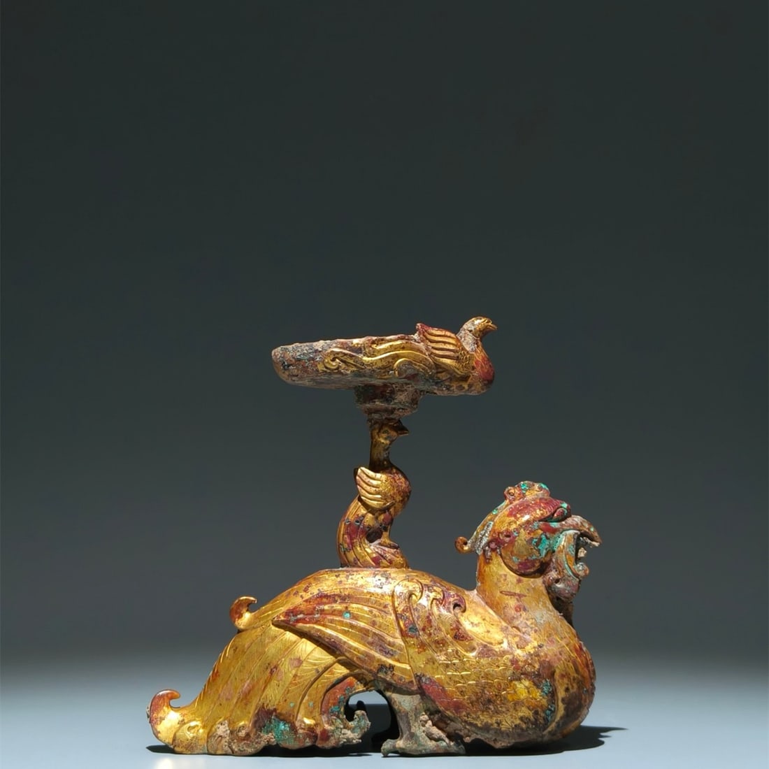 An Exquisite Gilt Bronze Phoenix-Shaped Candlestick: An Exquisite Gilt Bronze Phoenix-Shaped Candlestick,the Two Jin in Period in China,Size:7.1inx7.5inx2.2in 铜鎏金凤形烛台,中国两晋ą