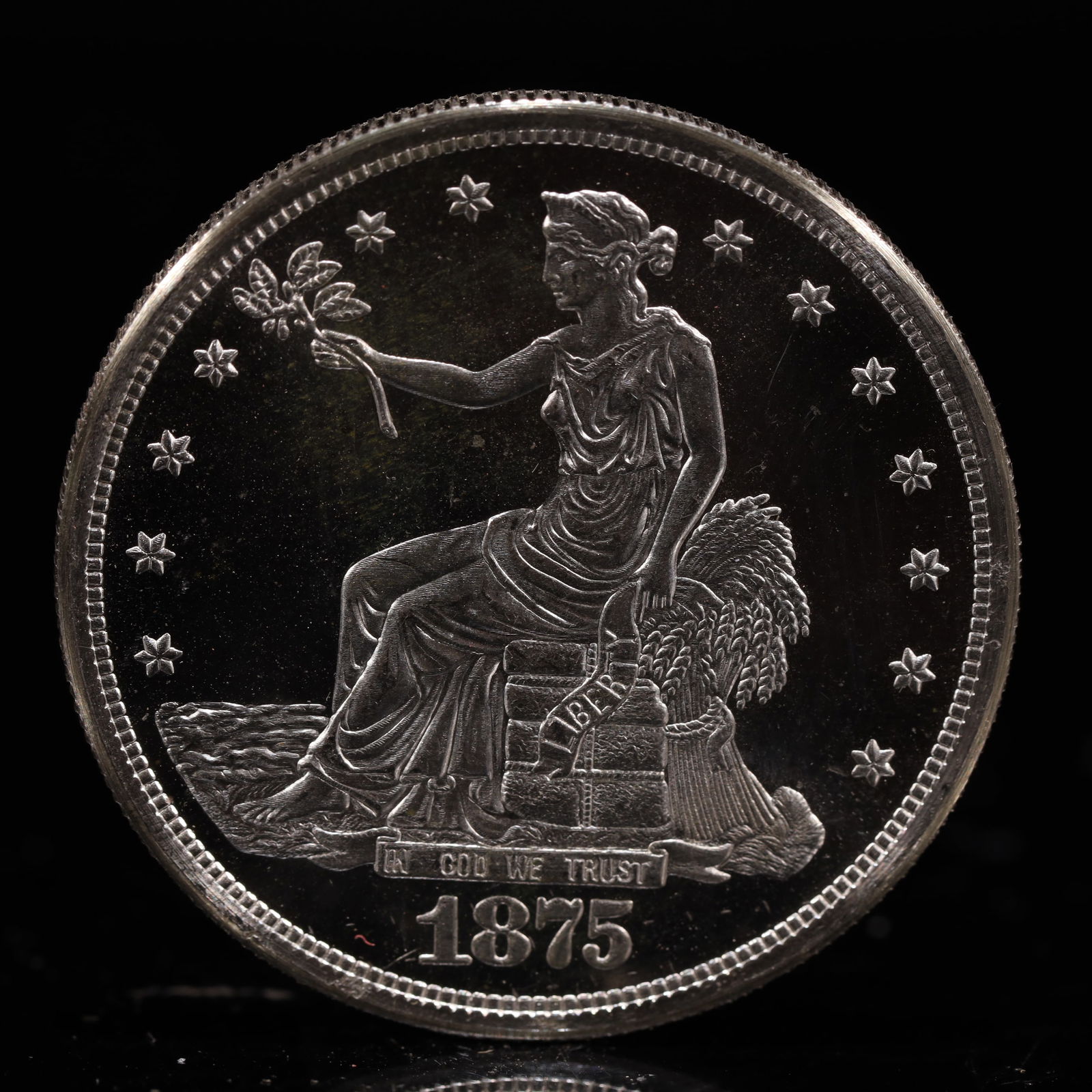 USA Trade Dollar 1875 Coin: American coin. Obverse: Liberty seated on a pedestal facing the sea to the left holding olive branches surrounded by 13 stars. IN GOD WE TRUST / LIBERTY / 1875. Reverse: An eagle holding branches