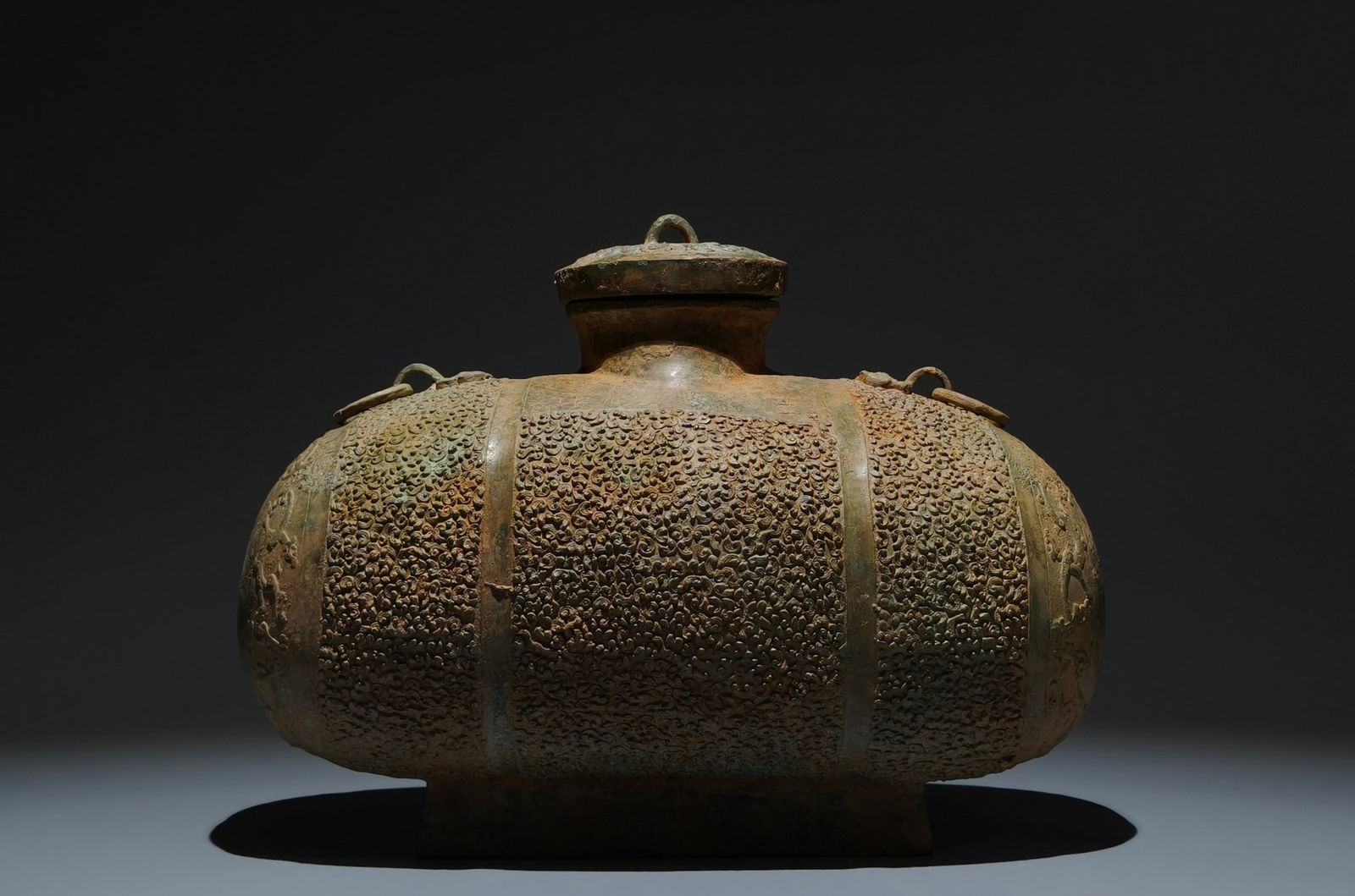 An Archaic Bronze Chi-Dragon Pattern Double-Ears Pot: An Archaic Bronze Chi-Dragon Pattern Double-Ears Pot,the Warring States period in China,Size:8.3inx11.4inx5.9in 青铜螭龙纹双耳壶,中国战