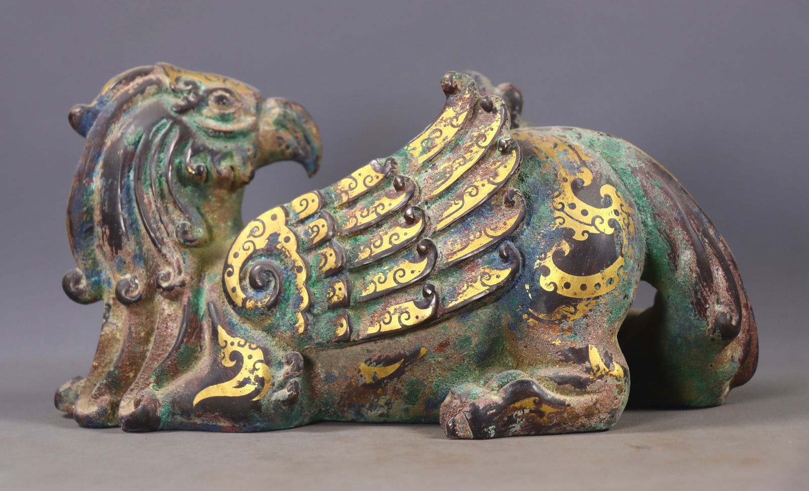 An Exquisite Bronze Inlaid Gold and Silver Auspicious Beast Ornament: An Exquisite Bronze Inlaid Gold and Silver Auspicious Beast Ornament,the Warring States period in China,Size:4.7inx8.7inx4.7in,Weight:1866g 