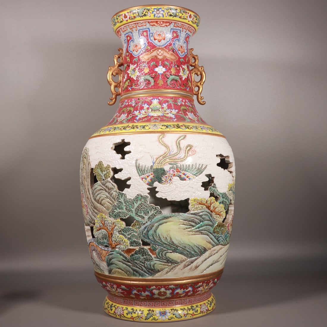 A Huge Famille-Rose Ruby Red-Ground Painted Gold Hollow Auspicious Cloud,Landscape and Phoenix: A Huge Famille-Rose Ruby Red-Ground Painted Gold Hollow Auspicious Cloud,Landscape and Phoenix Pattern Double-Ears Vase,Qing Dynasty, China,Qianlong Four-character Mark,Size:25.2inx12.6in 粉