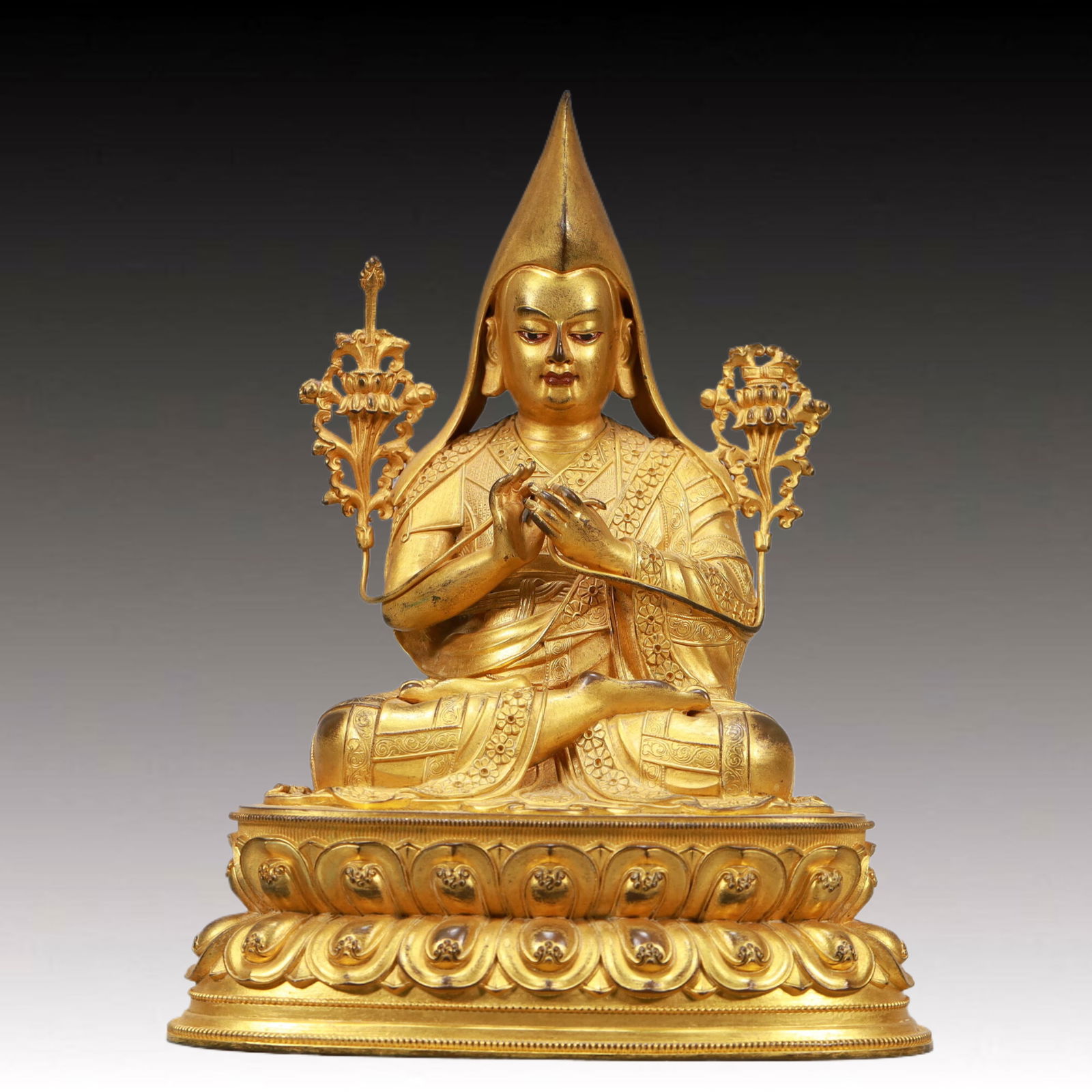 An Excellent Gilt-Bronze Figure Of Tsongkapa: An Excellent Gilt-Bronze Figure Of Tsongkapa. The figure with a dignified expression is rendered clad in long,flowing robes,the voluminous drapery elegantly cascading in folds,topknot surmounted by a