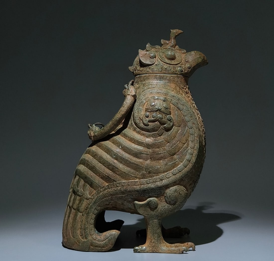 An Archaic Bronze Coiling Dragon Pattern Bird-Shaped Zun,With Inscription: An Archaic Bronze Coiling Dragon Pattern Bird-Shaped Zun,With Inscription,the Warring States period in China,Size:15.7inx9.8inx7.5in 