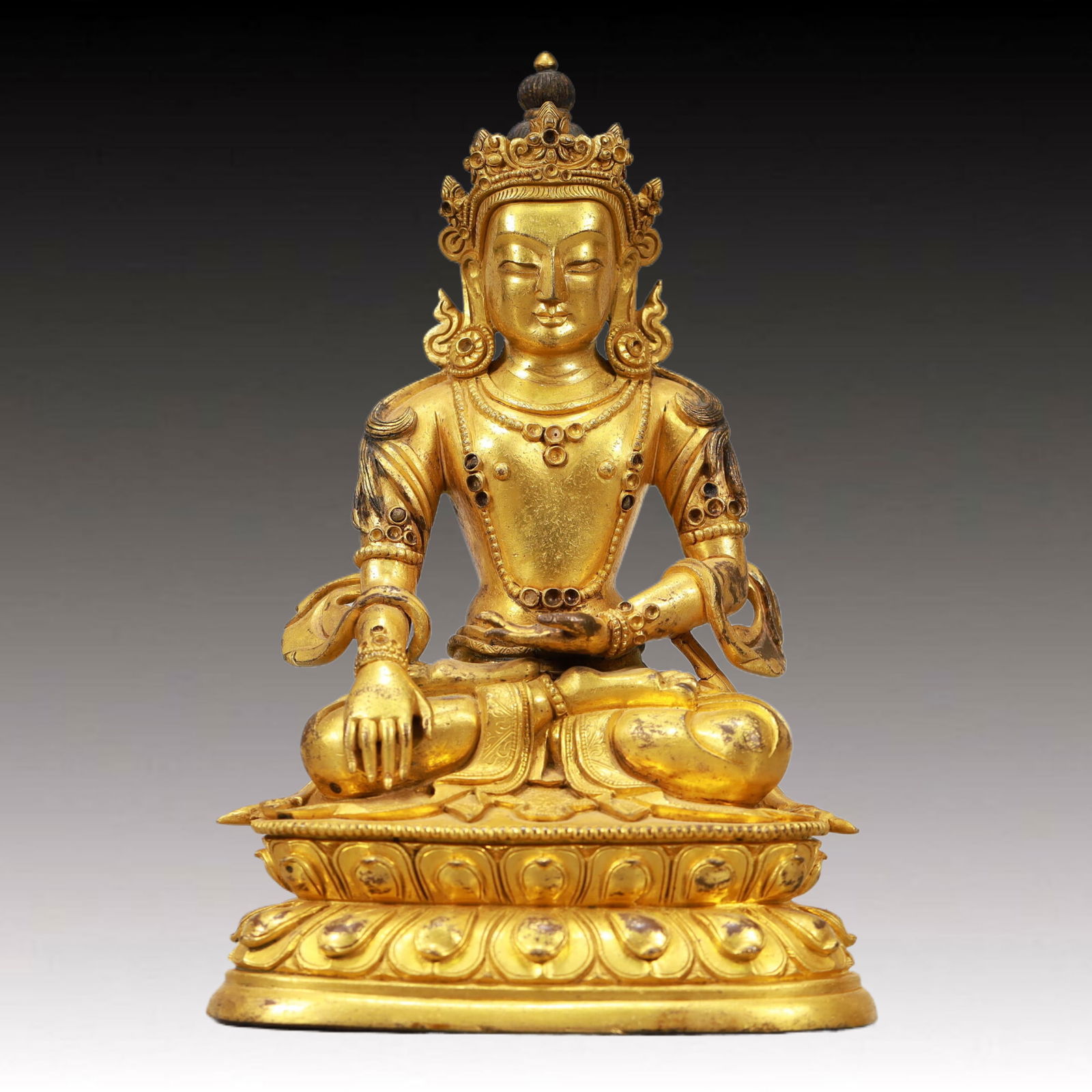 An Excellent Gilt-Bronze Figure Of Longevity Buddha: An Excellent Gilt-Bronze Figure Of Longevity Buddha. Seated on a base with a peaceful expression,body adorned with jewelry ornaments,topknot surmounted by a splendid diadem. Chinese Qing Dynasty.