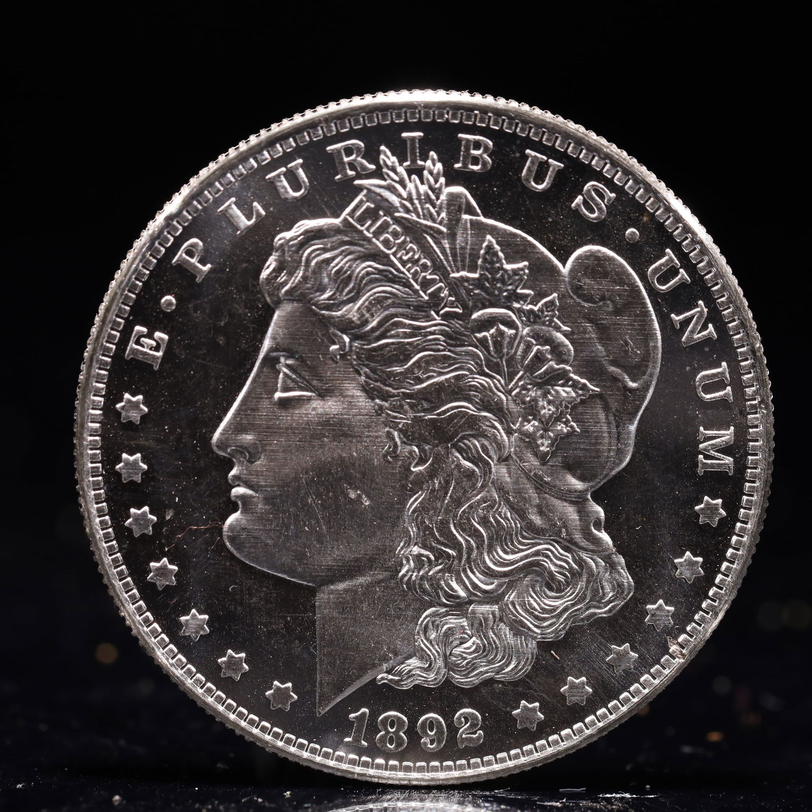 USA Morgan Dollar 1892 Coin: Obv: profile bust with date below and E PLURIBUS UNUM legend and stars around. Rev: eagle with In God we trust above within wreath with UNITED STATES OF AMERICA ONE DOLLAR legend. IN GOD WE TRUST /