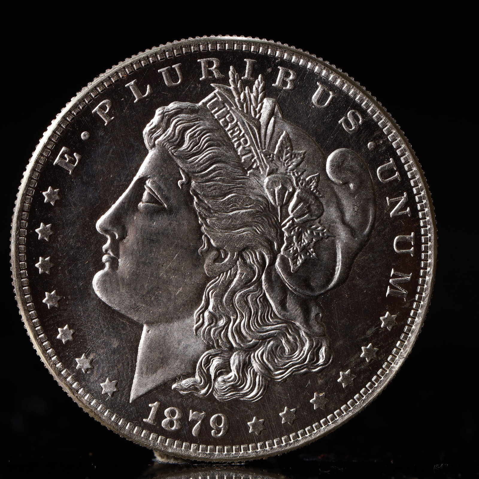 USA Morgan Dollar 1879 Coin: Obv: profile bust with date below and E PLURIBUS UNUM legend and stars around. Rev: eagle with In God we trust above within wreath with UNITED STATES OF AMERICA ONE DOLLAR legend. IN GOD WE TRUST / LI