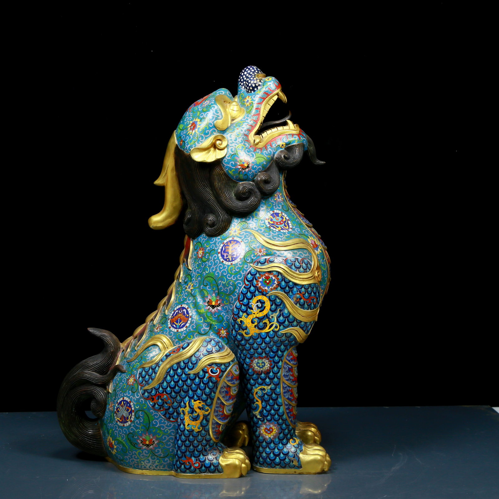An exquisite cloisonné unicorn ornament: A cloisonné unicorn ornament Qing Dynasty, China. The unicorn is lifelike and graceful, seeming to convey a message of auspiciousness and protection. The cloisonné blue background is dotted