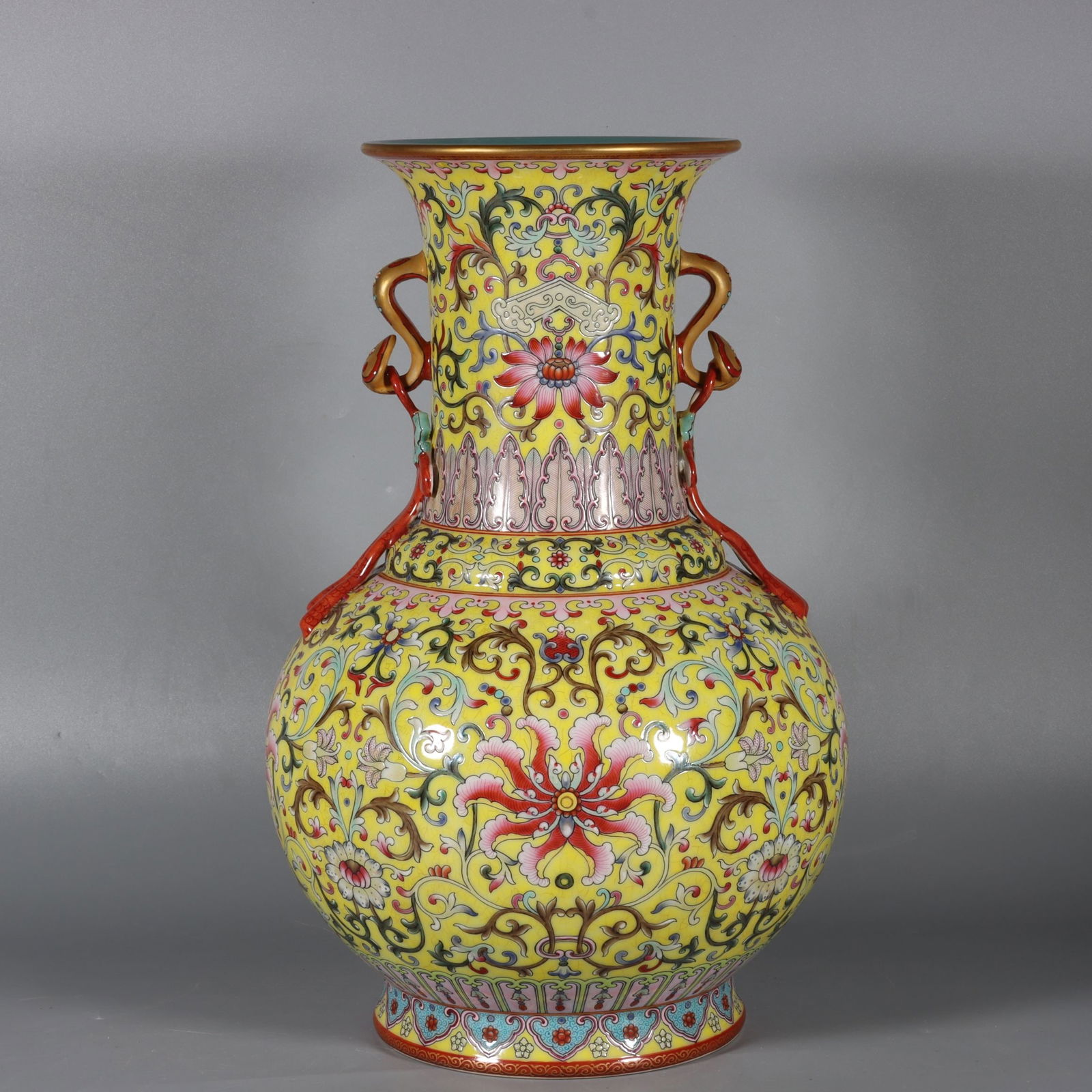 A Rare Famille-Rose Yellow Ground Painted Gold Lotus Pattern Ruyi-Ears Vase: A Rare Famille-Rose Yellow Ground Painted Gold Lotus Pattern Ruyi-Ears Vase,Qing Dynasty, China,Qianlong Six-character Mark,Size:14.4inx5.7inx5.8in 