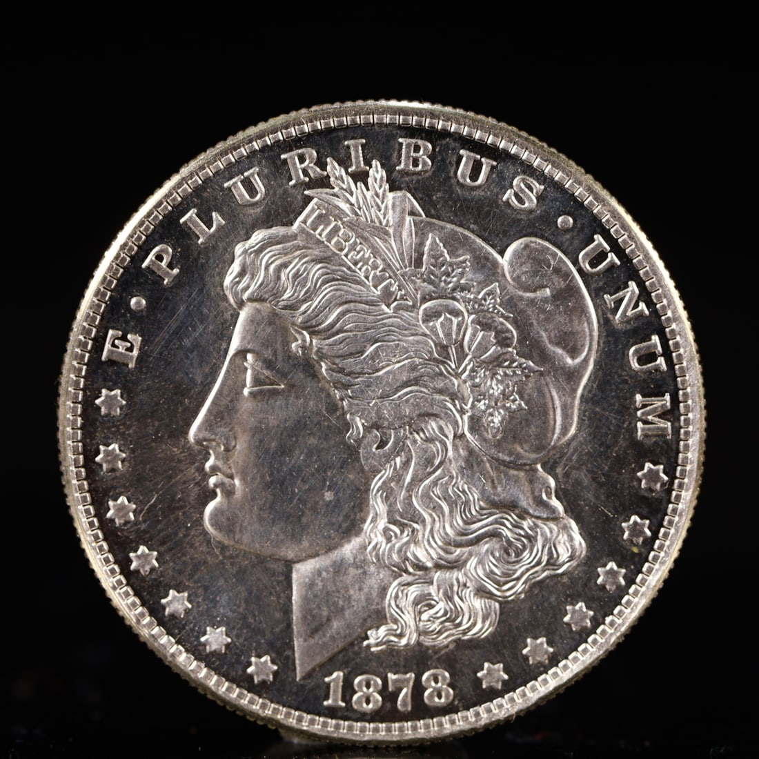 USA Morgan Dollar 1878 Coin: Obv: profile bust with date below and E PLURIBUS UNUM legend and stars around. Rev: eagle with In God we trust above within wreath with UNITED STATES OF AMERICA ONE DOLLAR legend. IN GOD WE TRUST / LI