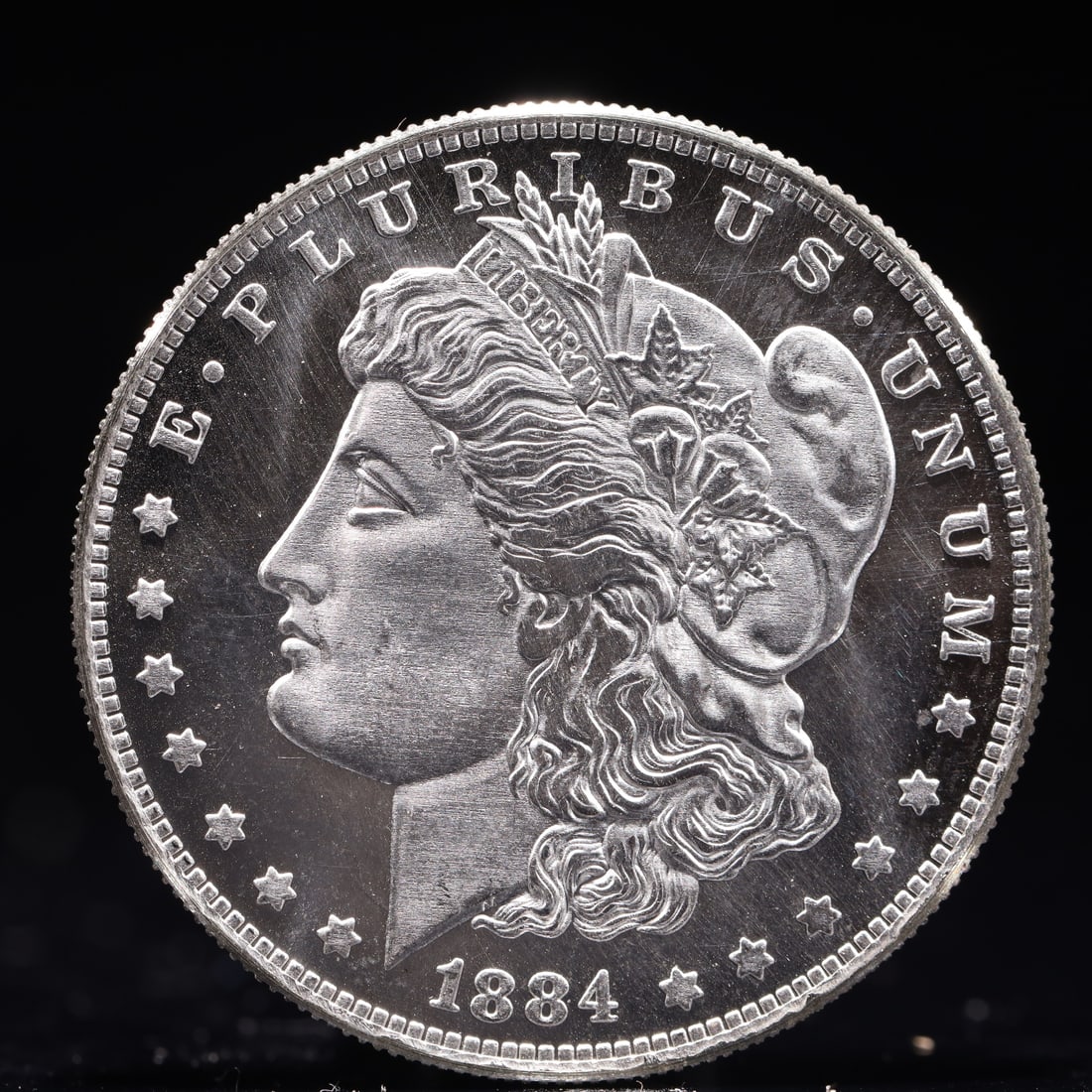 USA Morgan Dollar 1884 Coin: Obv: profile bust with date below and E PLURIBUS UNUM legend and stars around. Rev: eagle with In God we trust above within wreath with UNITED STATES OF AMERICA ONE DOLLAR legend. IN GOD WE TRUST / LI