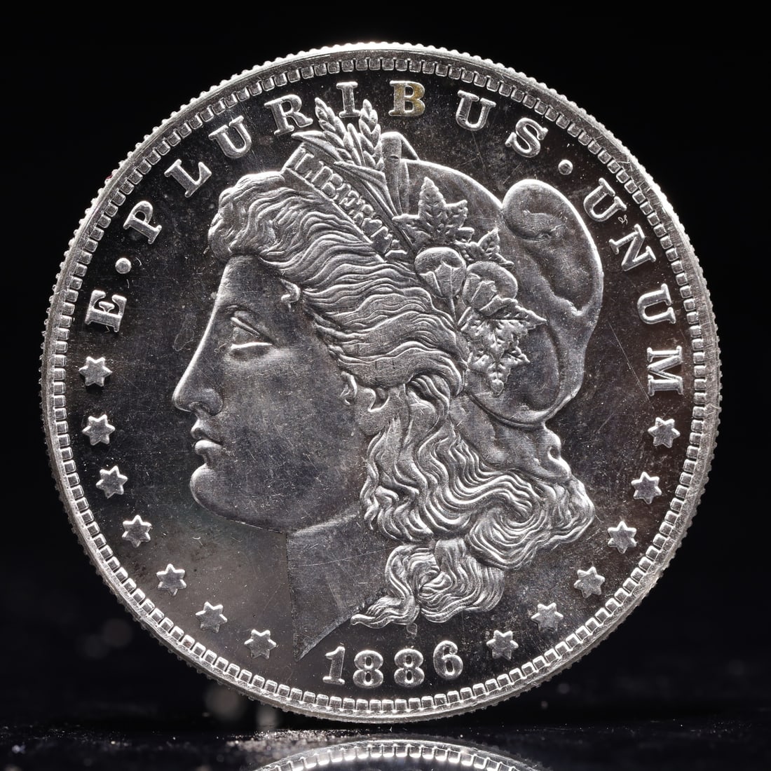 USA Morgan Dollar 1886 Coin: Obv: profile bust with date below and E PLURIBUS UNUM legend and stars around. Rev: eagle with In God we trust above within wreath with UNITED STATES OF AMERICA ONE DOLLAR legend. IN GOD WE TRUST /