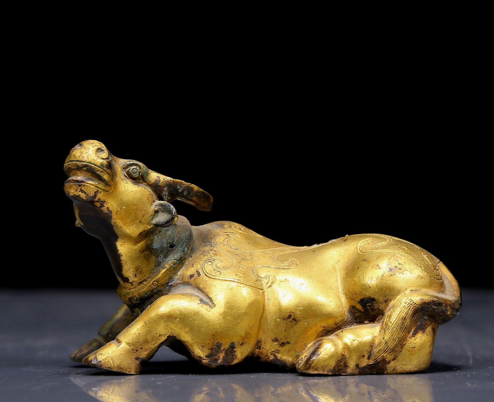 An Exquisite Gilt Bronze Buffalo Ornament: An Exquisite Gilt Bronze Buffalo Ornament，Qing Dynasty, China，Size:4.1inx2.4inx2.2in，Weight:315g 铜鎏金牛摆件，清代