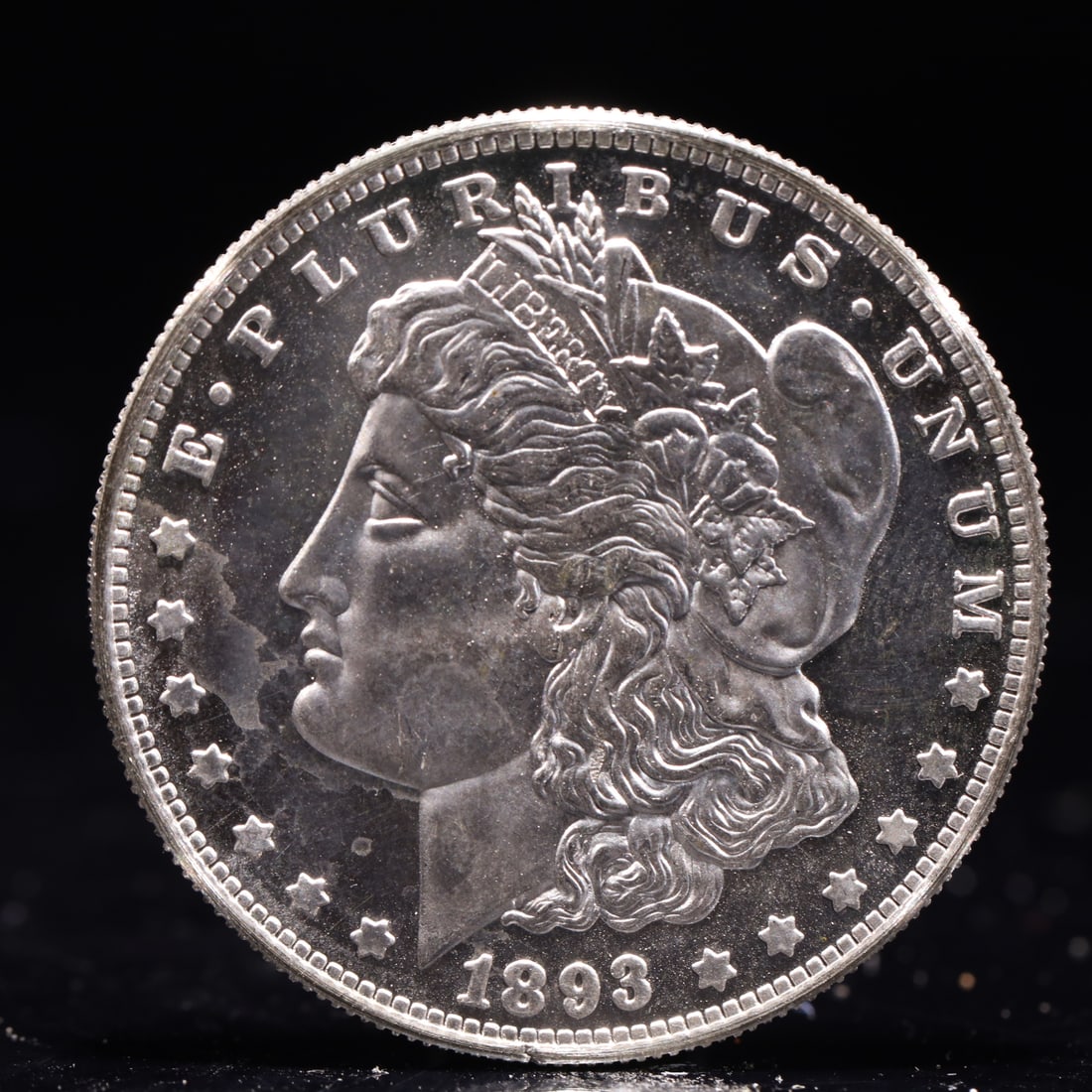 USA Morgan Dollar 1893 Coin: Obv: profile bust with date below and E PLURIBUS UNUM legend and stars around. Rev: eagle with In God we trust above within wreath with UNITED STATES OF AMERICA ONE DOLLAR legend. IN GOD WE TRUST /