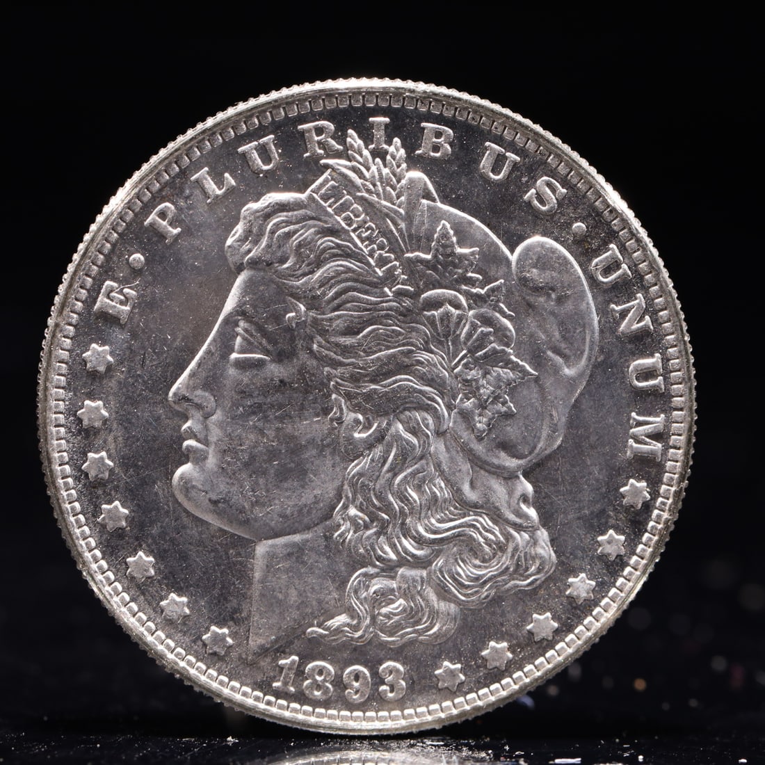 USA Morgan Dollar 1893 Coin: Obv: profile bust with date below and E PLURIBUS UNUM legend and stars around. Rev: eagle with In God we trust above within wreath with UNITED STATES OF AMERICA ONE DOLLAR legend. IN GOD WE TRUST / LI