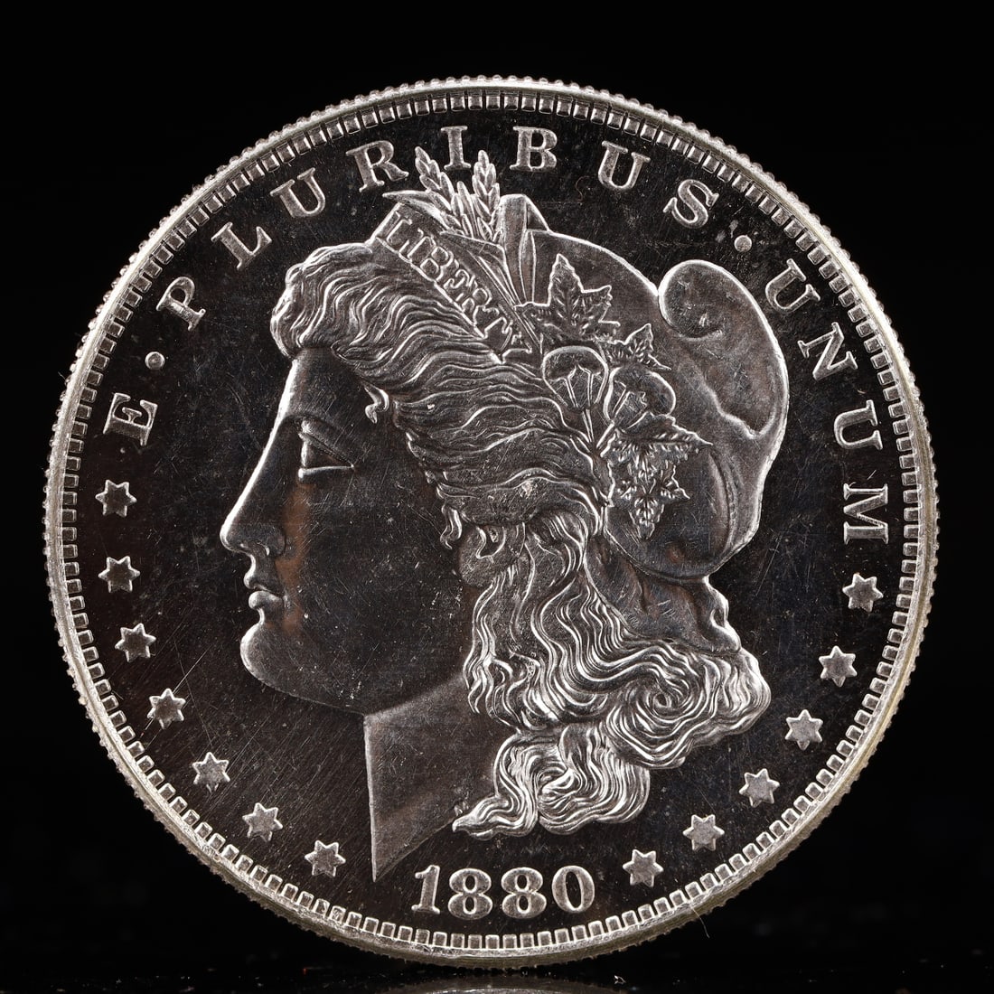USA Morgan Dollar 1880 Coin: Obv: profile bust with date below and E PLURIBUS UNUM legend and stars around. Rev: eagle with In God we trust above within wreath with UNITED STATES OF AMERICA ONE DOLLAR legend. IN GOD WE TRUST / LI