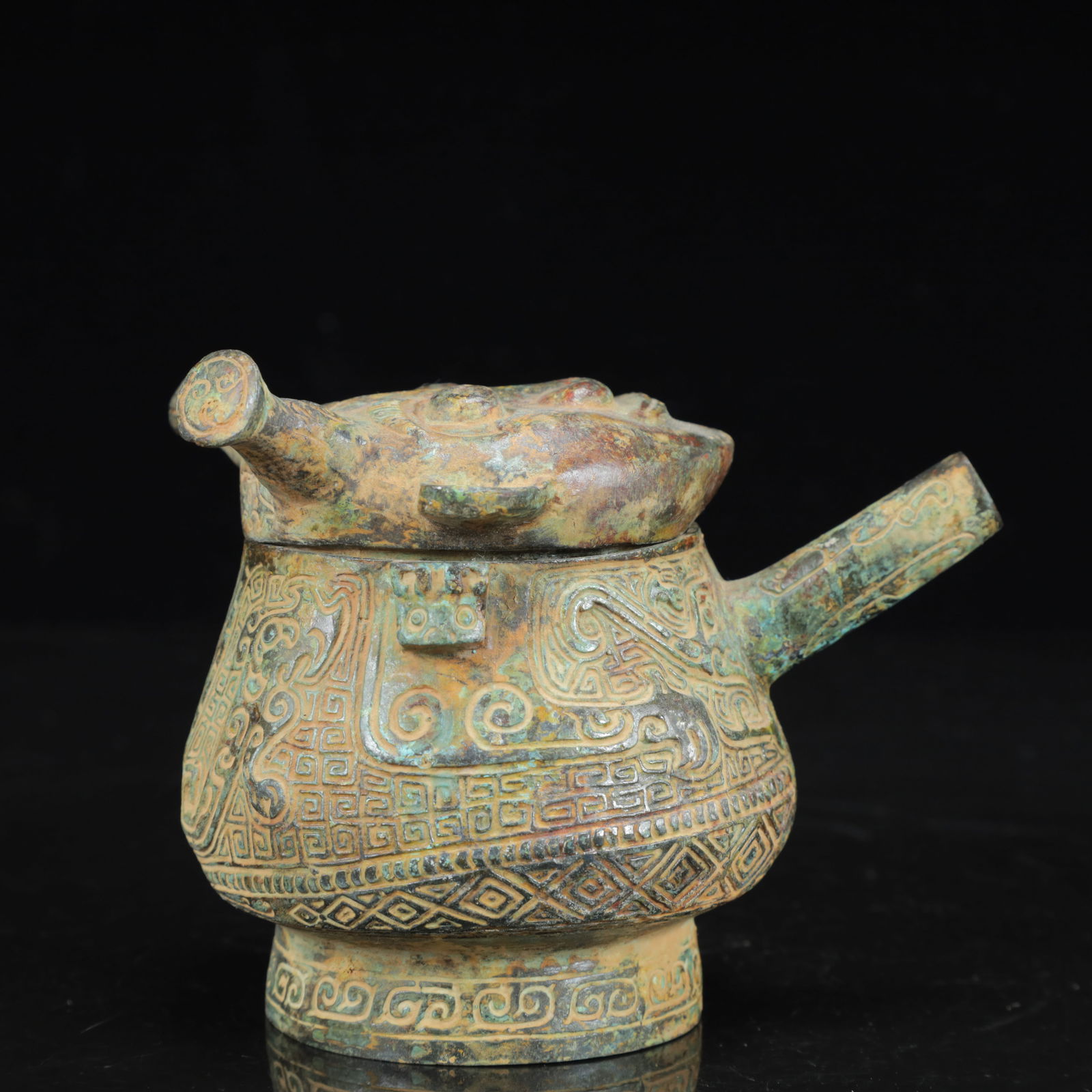An Archaic Bronze Figure-Face Pattern Beast-Ears Pot: An Archaic Bronze Figure-Face Pattern Beast-Ears Pot,the Warring States Period in China,Size:4.7inx3.5inx4.3in,Weight:750g 青铜人面纹兽耳壶,中