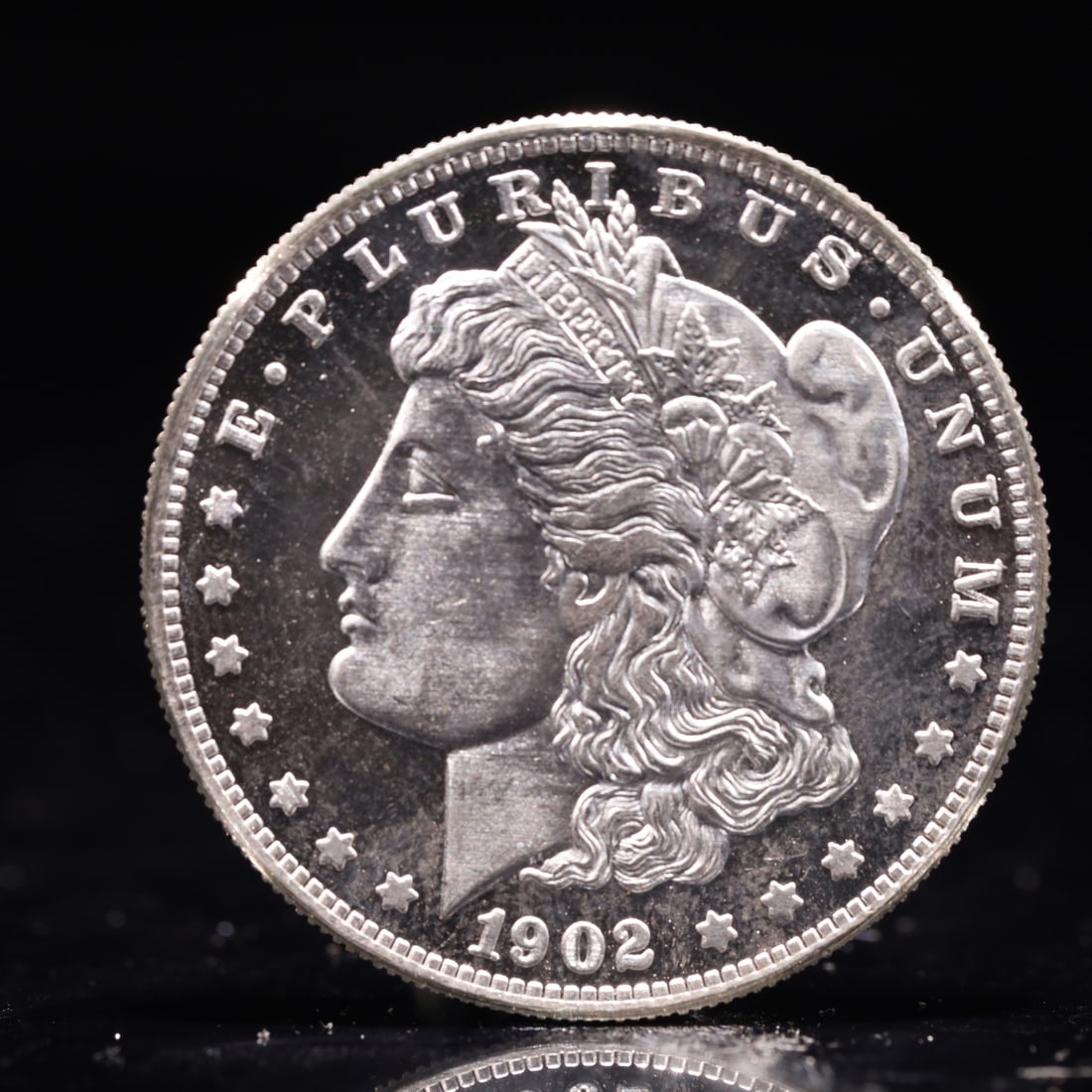 USA Morgan Dollar 1902 Coin: Obv: profile bust with date below and E PLURIBUS UNUM legend and stars around. Rev: eagle with In God we trust above within wreath with UNITED STATES OF AMERICA ONE DOLLAR legend. IN GOD WE TRUST / LI