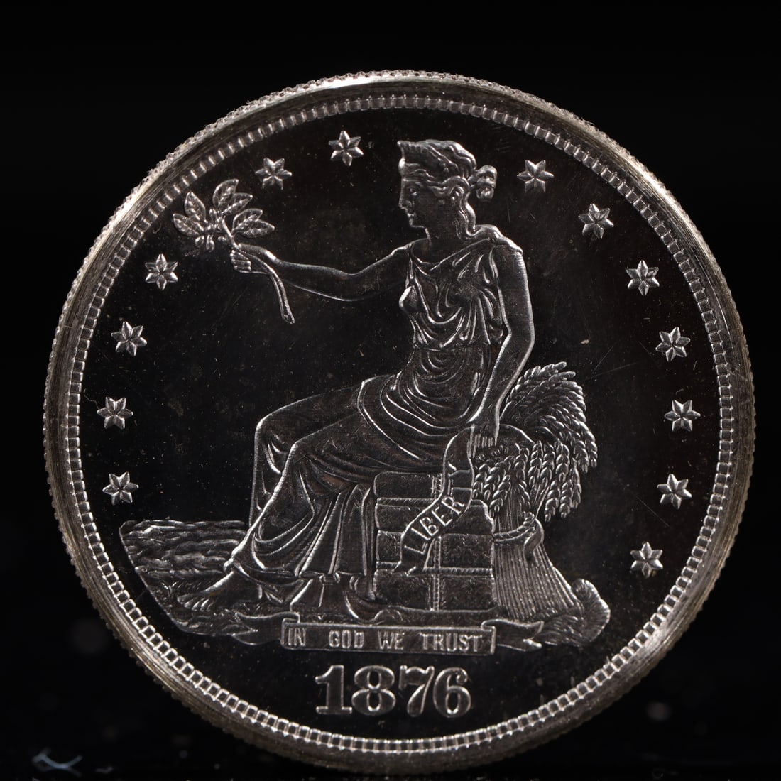 USA Trade Dollar 1876 Coin: American coin. Obverse: Liberty seated on a pedestal facing the sea to the left holding olive branches surrounded by 13 stars. IN GOD WE TRUST / LIBERTY / 1876. Reverse: An eagle holding branches with