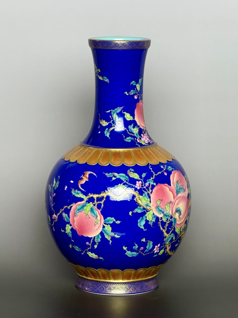 An Exquisite Sapphire Blue Glazed Famille-Rose Painted Gold Bats and Peach Pattern Vase: An Exquisite Sapphire Blue Glazed Famille-Rose Painted Gold Bats and Peach Pattern Vase,Qing Dynasty,China,Qianlong Six-character Mark,Size:12.6inx7.1in 宝石蓝釉粉彩