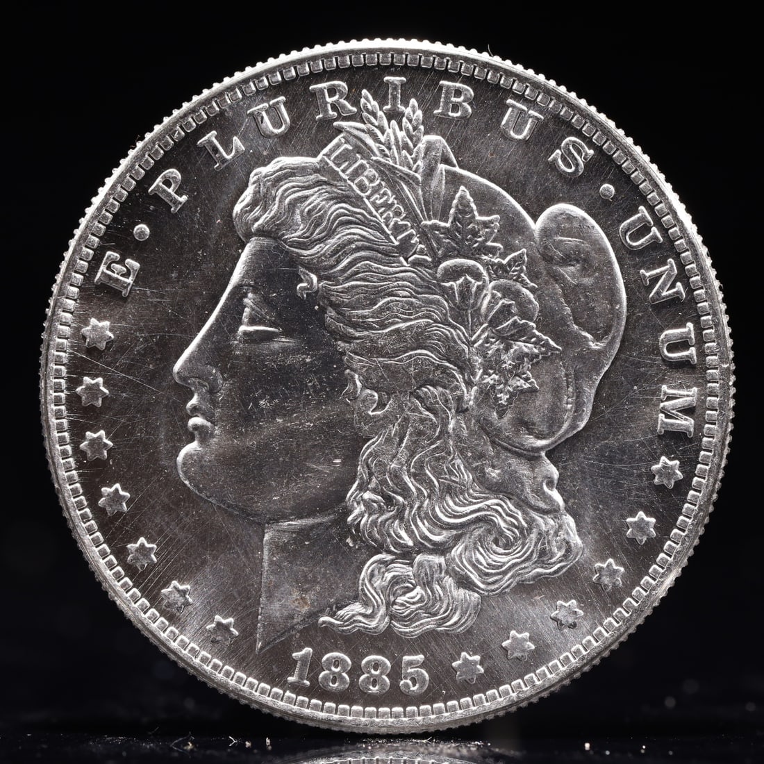 USA Morgan Dollar 1885 Coin: Obv: profile bust with date below and E PLURIBUS UNUM legend and stars around. Rev: eagle with In God we trust above within wreath with UNITED STATES OF AMERICA ONE DOLLAR legend. IN GOD WE TRUST /