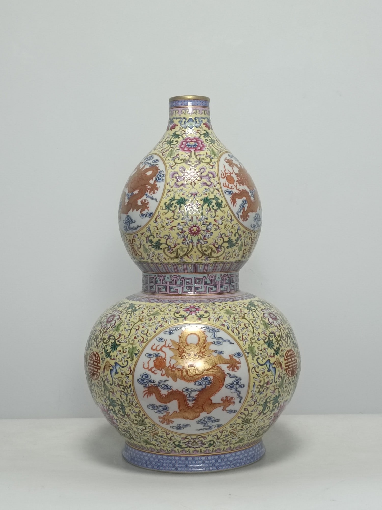 An Exquisite Famille-Rose Yellow Ground Auspicious Cloud and Dragon Pattern Gourd-Shaped Vase: An Exquisite Famille-Rose Yellow Ground Auspicious Cloud and Dragon Pattern Gourd-Shaped Vase,Qing Dynasty,China,Qianlong Four-character Mark,Size:20.5inx12.2in 
