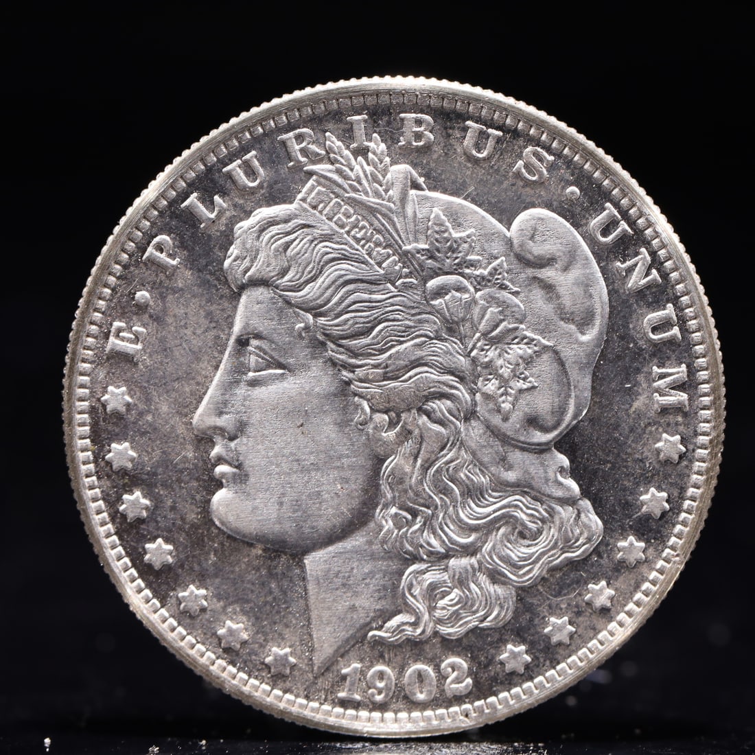 USA Morgan Dollar 1902 Coin: Obv: profile bust with date below and E PLURIBUS UNUM legend and stars around. Rev: eagle with In God we trust above within wreath with UNITED STATES OF AMERICA ONE DOLLAR legend. IN GOD WE TRUST /