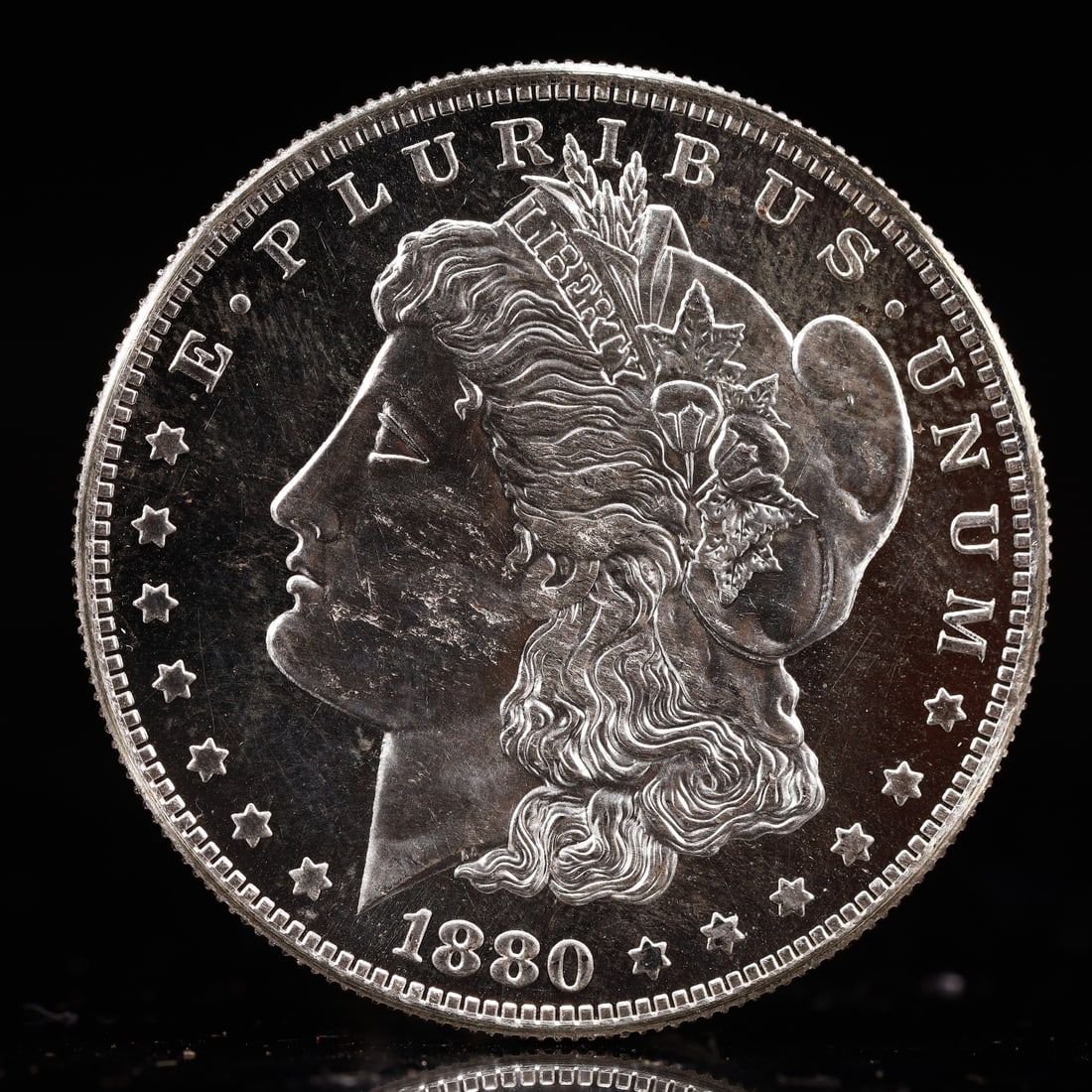 USA Morgan Dollar 1880 Coin: Obv: profile bust with date below and E PLURIBUS UNUM legend and stars around. Rev: eagle with In God we trust above within wreath with UNITED STATES OF AMERICA ONE DOLLAR legend. IN GOD WE TRUST /