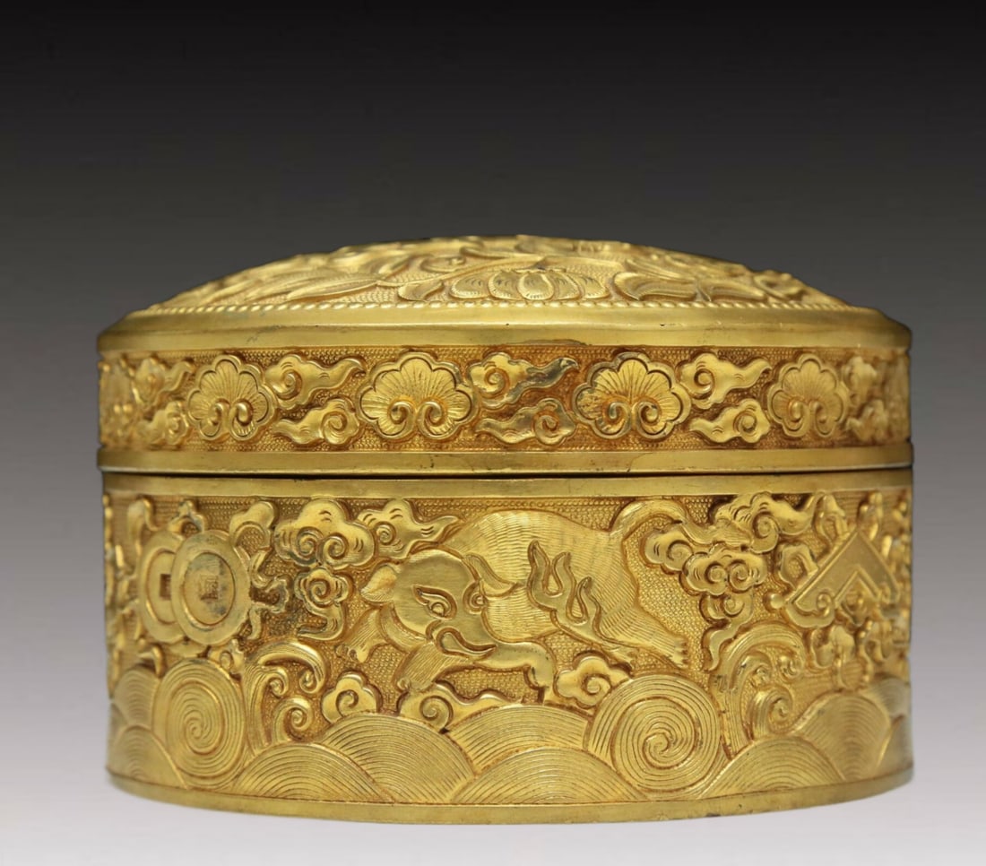 A Magnificent Gilt-Bronze 'Flower& Auspicious Beast' Box: A Magnificent Gilt-Bronze 'Flower& Auspicious Beast' Box. The beast on the cover is cast with its mouth open, revealing fangs, all amidst leafy flowers. Chinese Qing Dynasty. Qianlong Four-Character