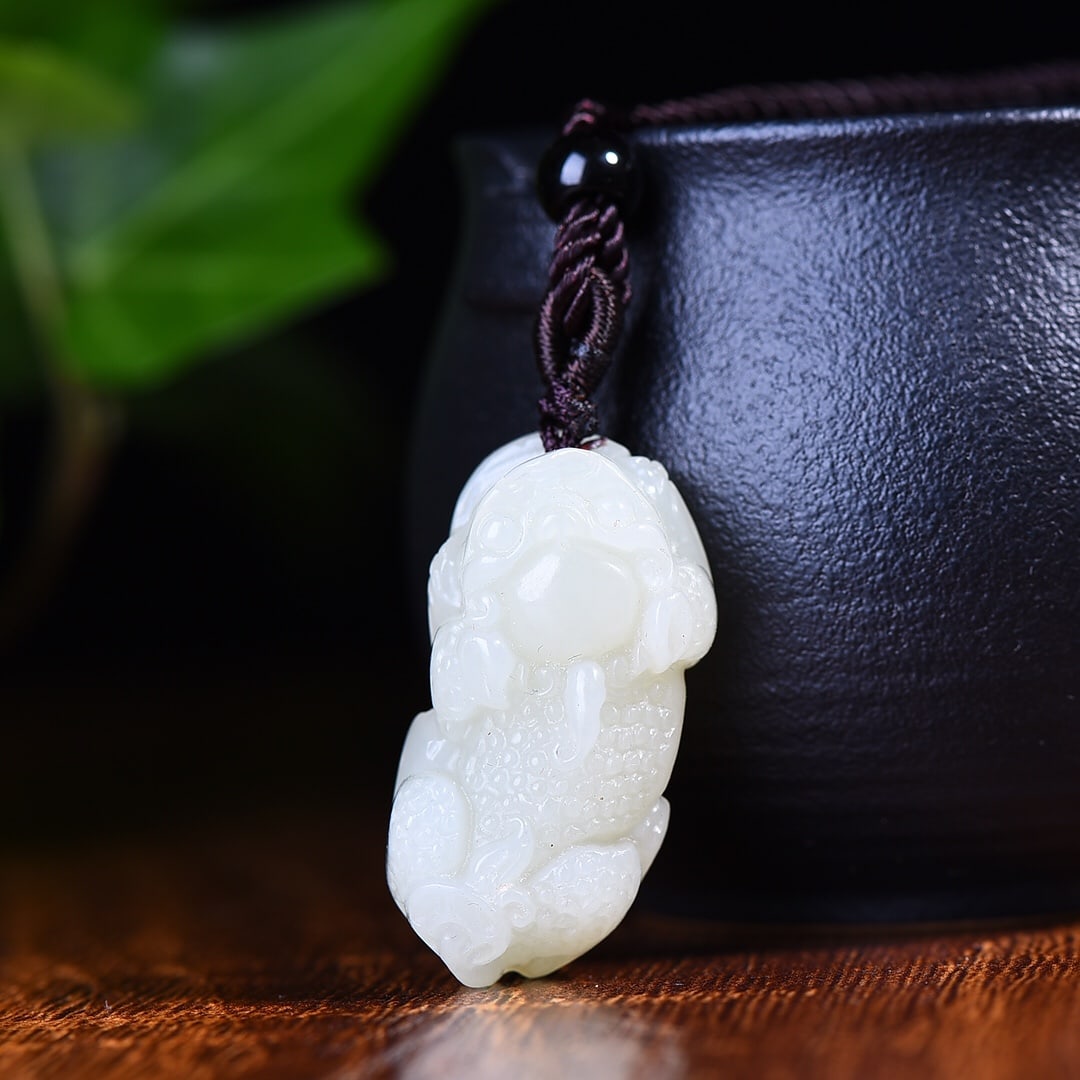 An Exquisite White Jade Wealth-Attracting Creature Pendant: An Exquisite White Jade Wealth-Attracting Creature Pendant,Size:0.7inx1.3in 白玉貔貅挂件