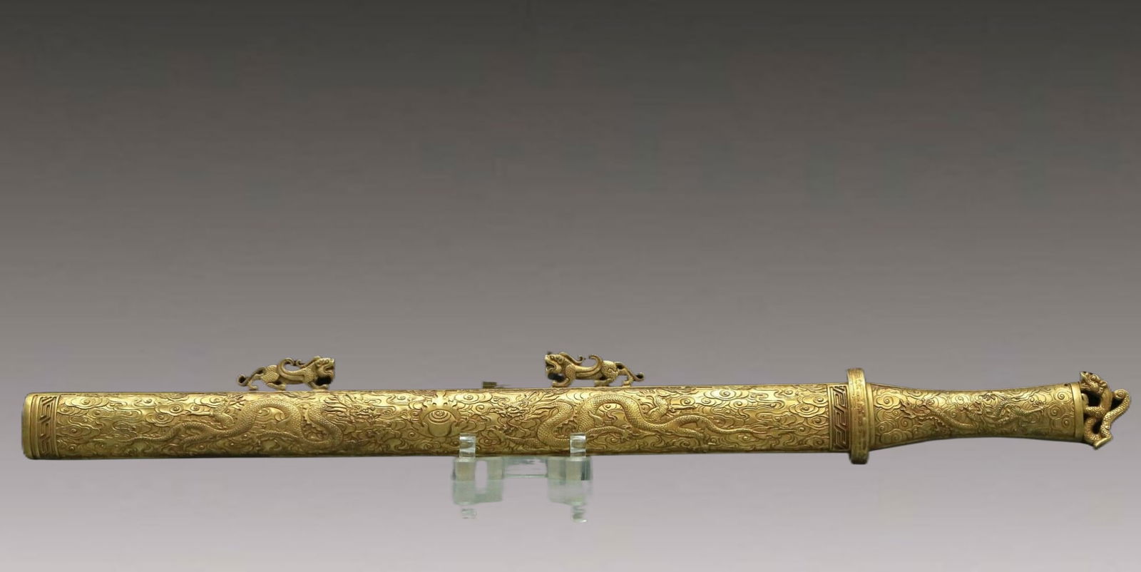 A Magnificent Gilt-Bronze Inlaid Gems 'Auspicious Beast' Ornament: A Magnificent Gilt-Bronze Inlaid Gems 'Dragon' Ornament. Chinese Qing Dynasty. Size:27.8inx2.6in 清代 铜鎏金祥云龙纹剑