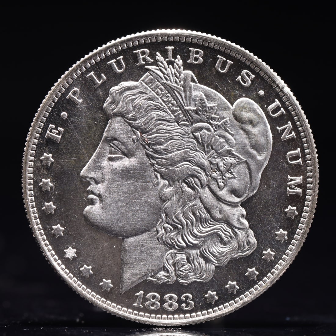 USA Morgan Dollar 1883 Coin: Obv: profile bust with date below and E PLURIBUS UNUM legend and stars around. Rev: eagle with In God we trust above within wreath with UNITED STATES OF AMERICA ONE DOLLAR legend. IN GOD WE TRUST / LI